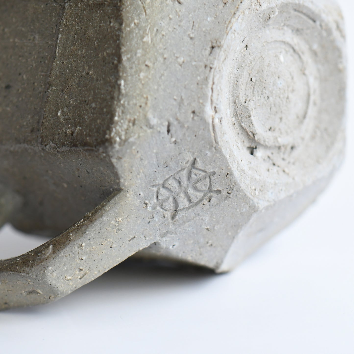 Bottom view of Seihitsu Sueki Mug Small #2 with circular foot ring and impressed artist mark on textured clay base.