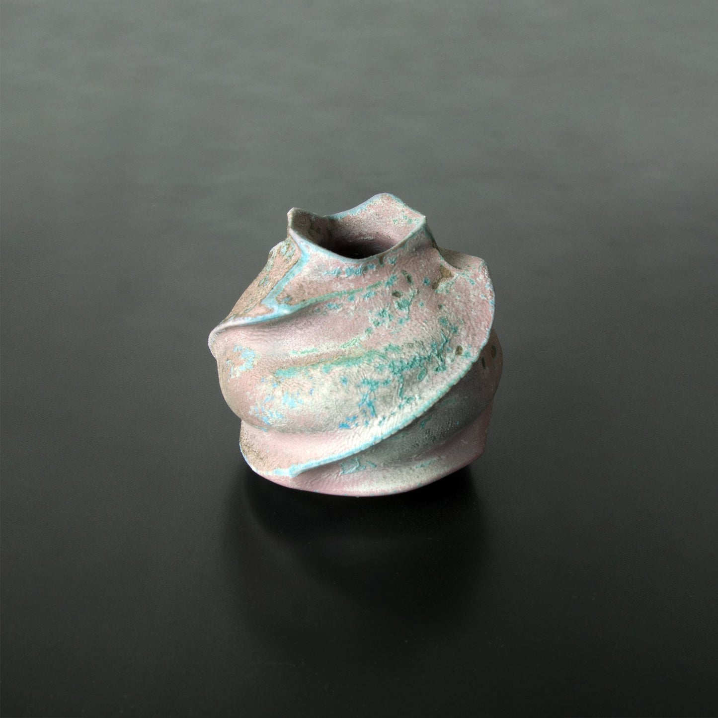 Handmade Japanese bud vase Anagama Kinyo has four random patterns of blue/green and a subtle pink/beige textured background. It is a one-of-a-kind, beautiful flower vase.