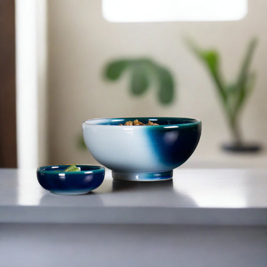 Handmade Seto Blue donburi bowl by Yoshito Takenishi, indigo-to-teal glaze, filled with rice on modern table.