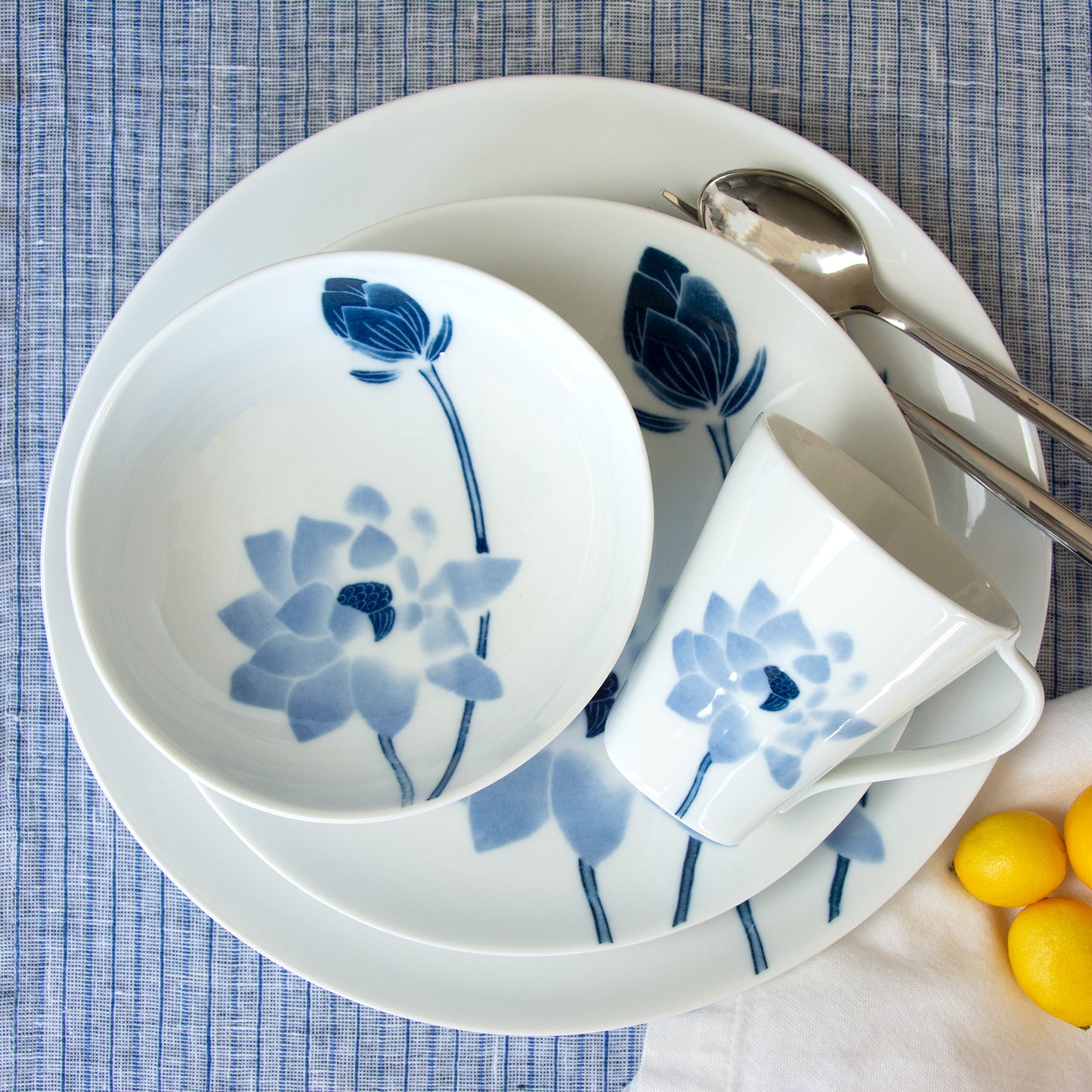 White Hasu Japanese tableware with blue lotus painting. Oval shaped plates and bowl.