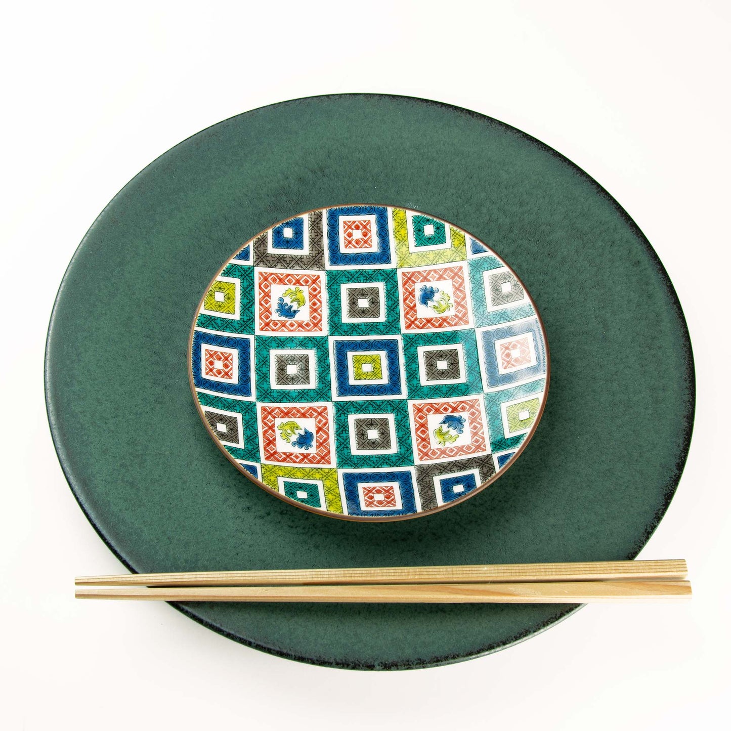 Red, blue, yellow, green, gray, square patterns on round dish paired with Koku dish