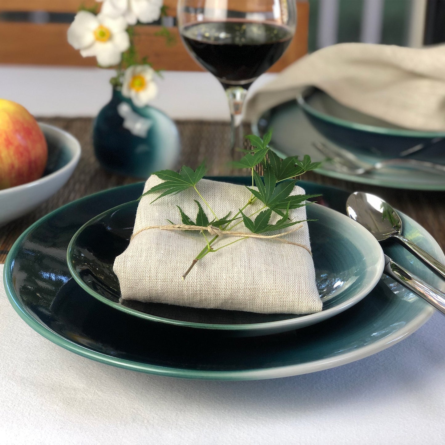 Japanese modern dinnerware place setting Seto Blue shown with cloth napkin finished with twig of Japanese Maple