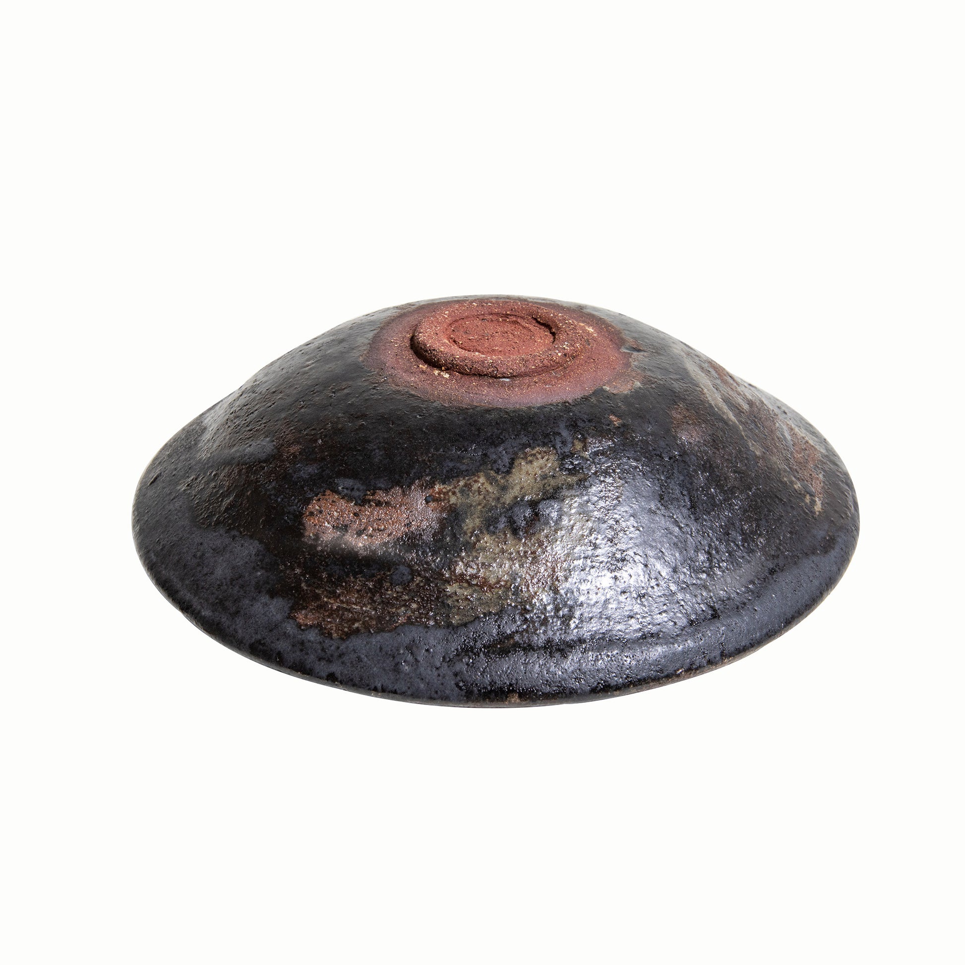 The back view of the bowl. The bottom is unglazed and reddish-brown clay.