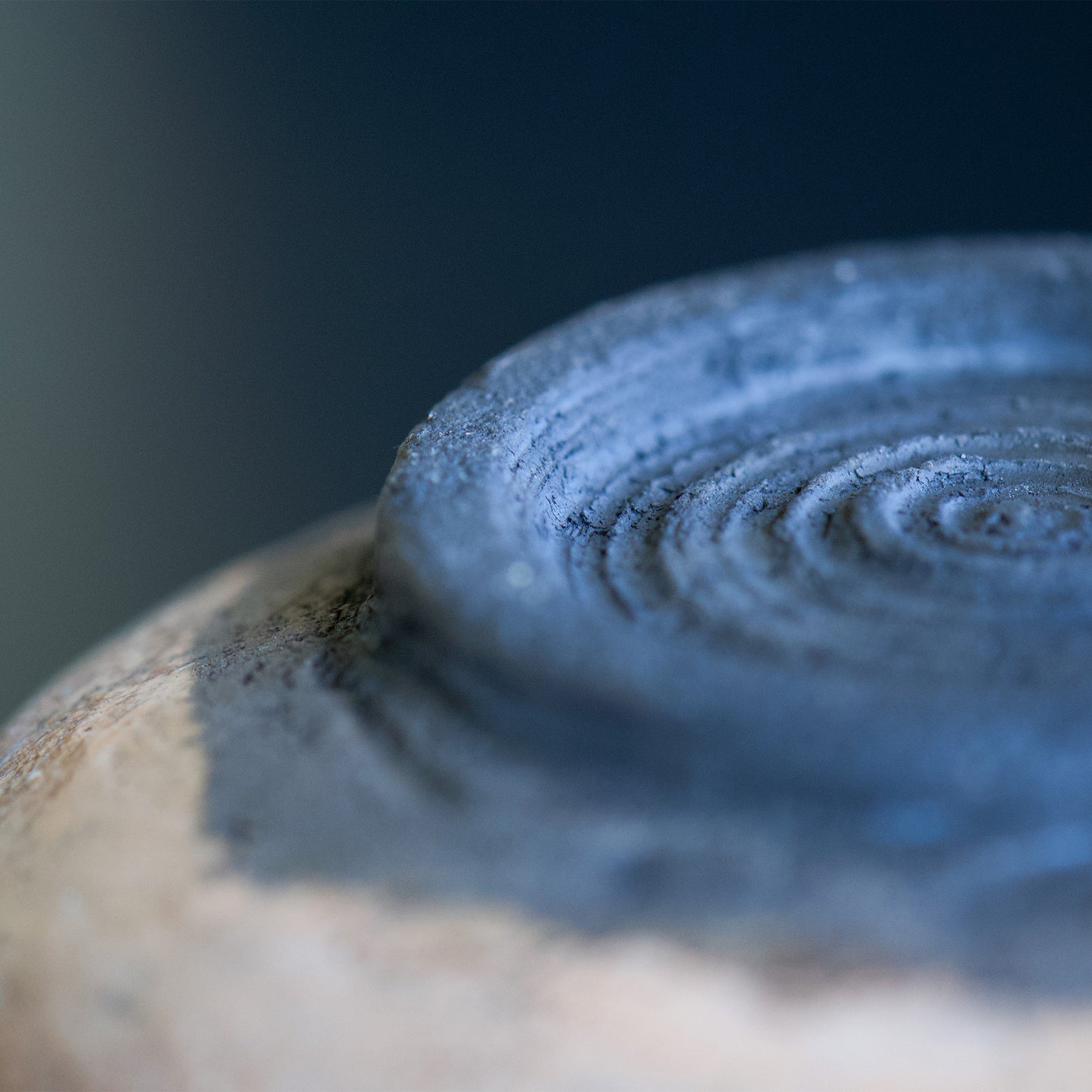 The cup has a natural, unglazed bottom that highlights the earthy and organic atmosphere, adding to the wabi sabi aesthetic of the piece.