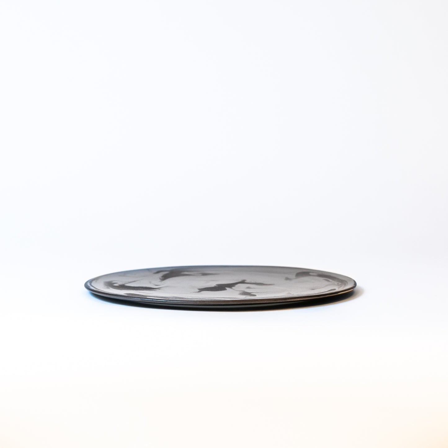 Side view of the plate. About 0.5 inches high. Beautiful flat plate.