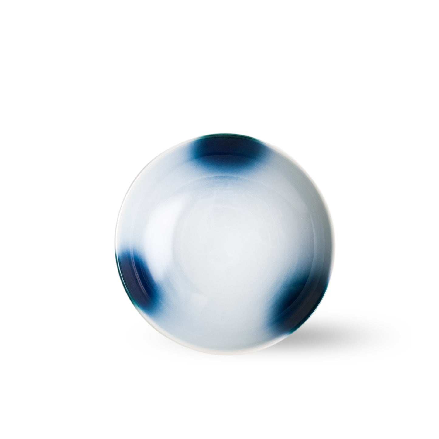 op-down view of round Mizu-oto pasta bowl with white center and watercolor-like dark blue patches.