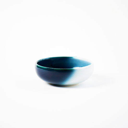 Isolated view of Shima Blue shoyu dish—small round bowl with white-to-navy ombré glaze by Yoshito Takenishi.