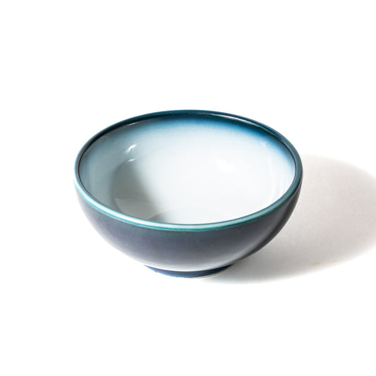 Overhead angle of Shima White Japanese donburi bowl showcasing spacious white well and blue ombré rim.