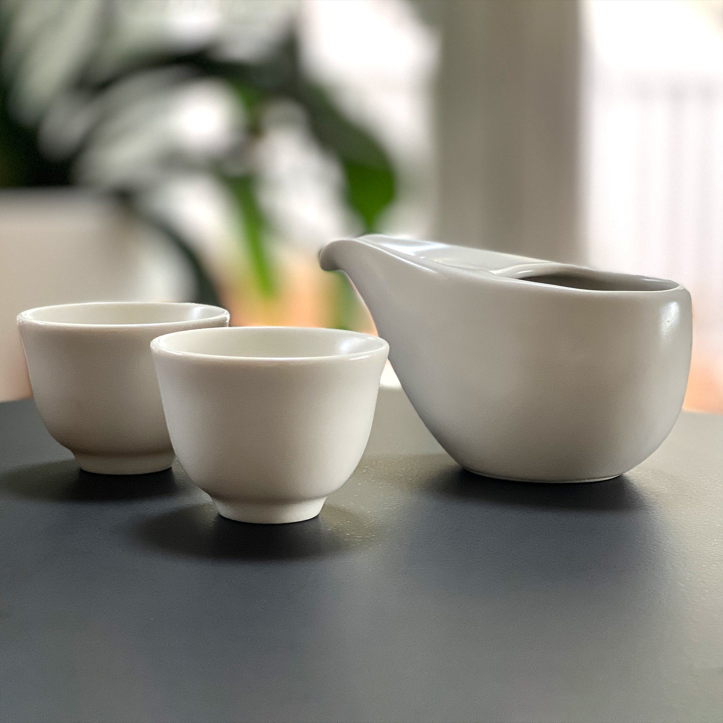 White smooth modern tea pot and 2 matching cups