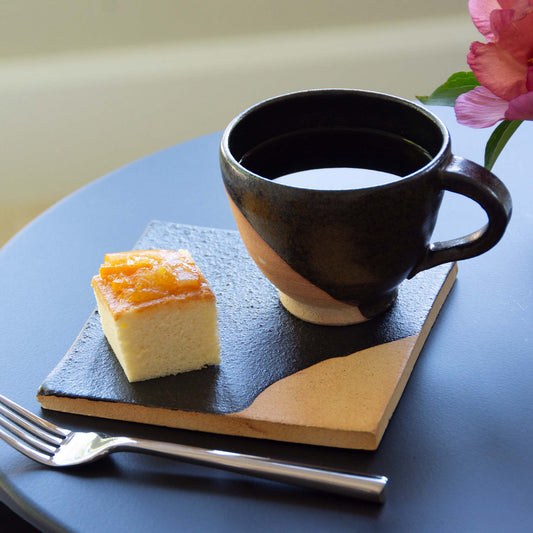Handmade clay coffee/tea cup on square tile dish