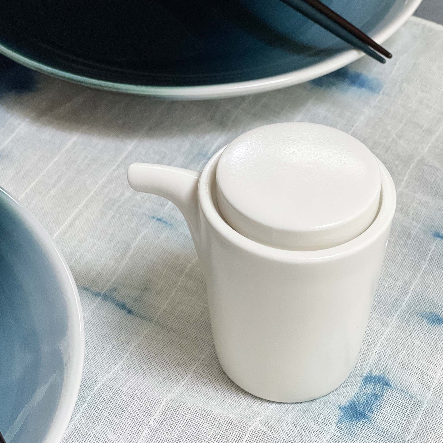 White, cylindrical designed shoyu container perfect for sushi night
