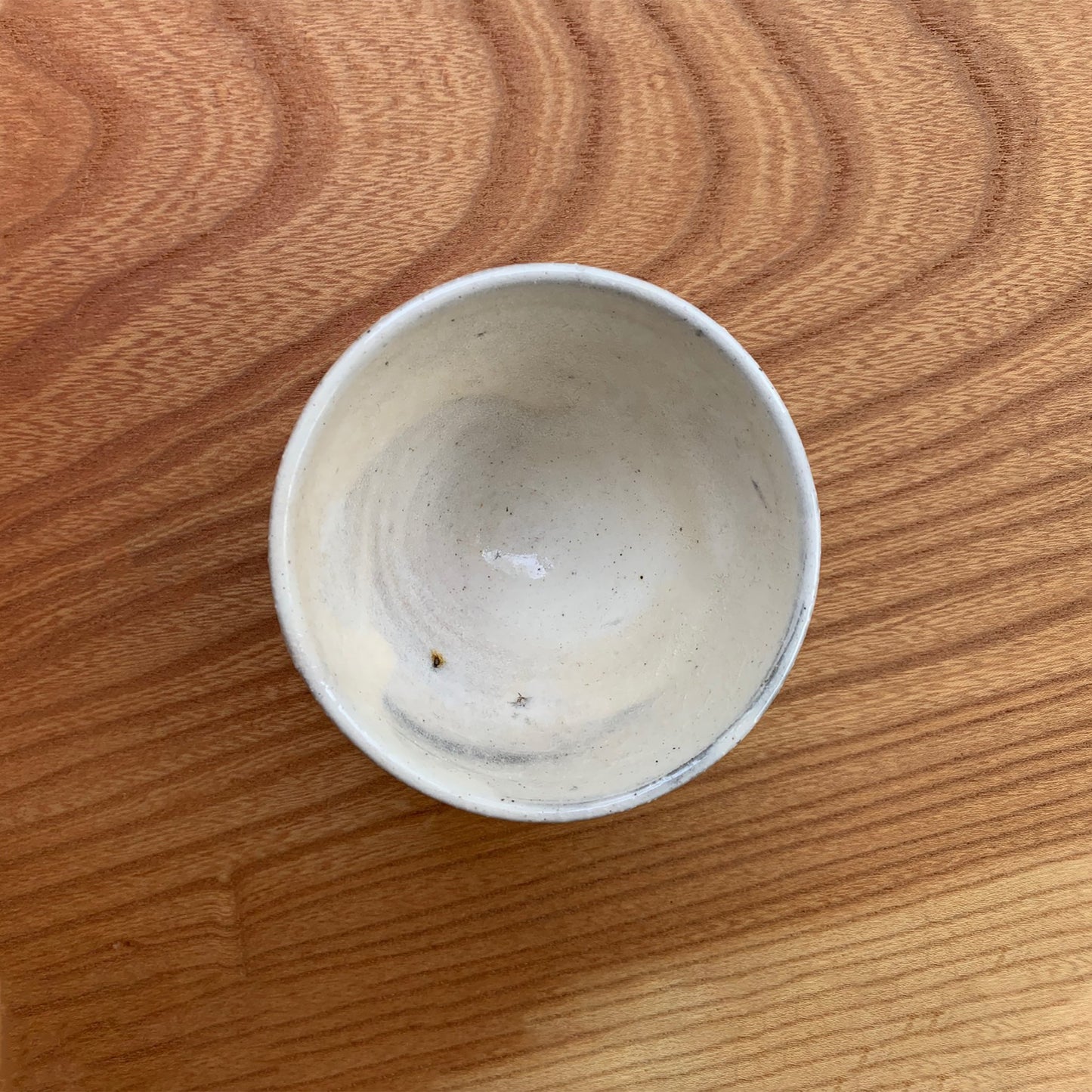 Uneven off white glaze hint of brown clay showing through
