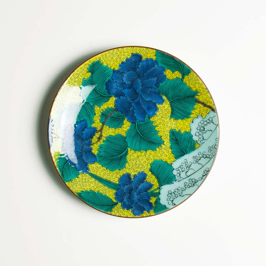 Rich blue peonies and green leaves set on a background of yellow and blue waves