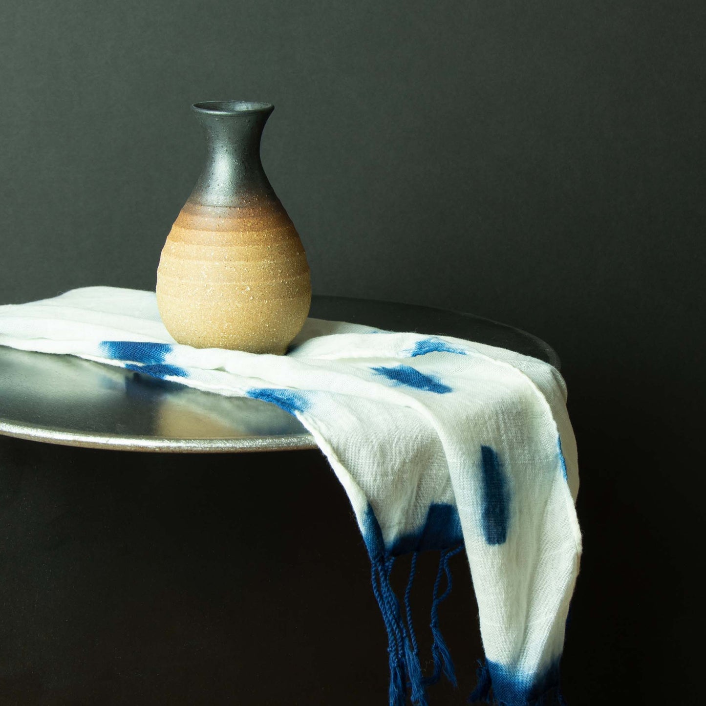 Dark brown glaze diffusing to clay colored sake container