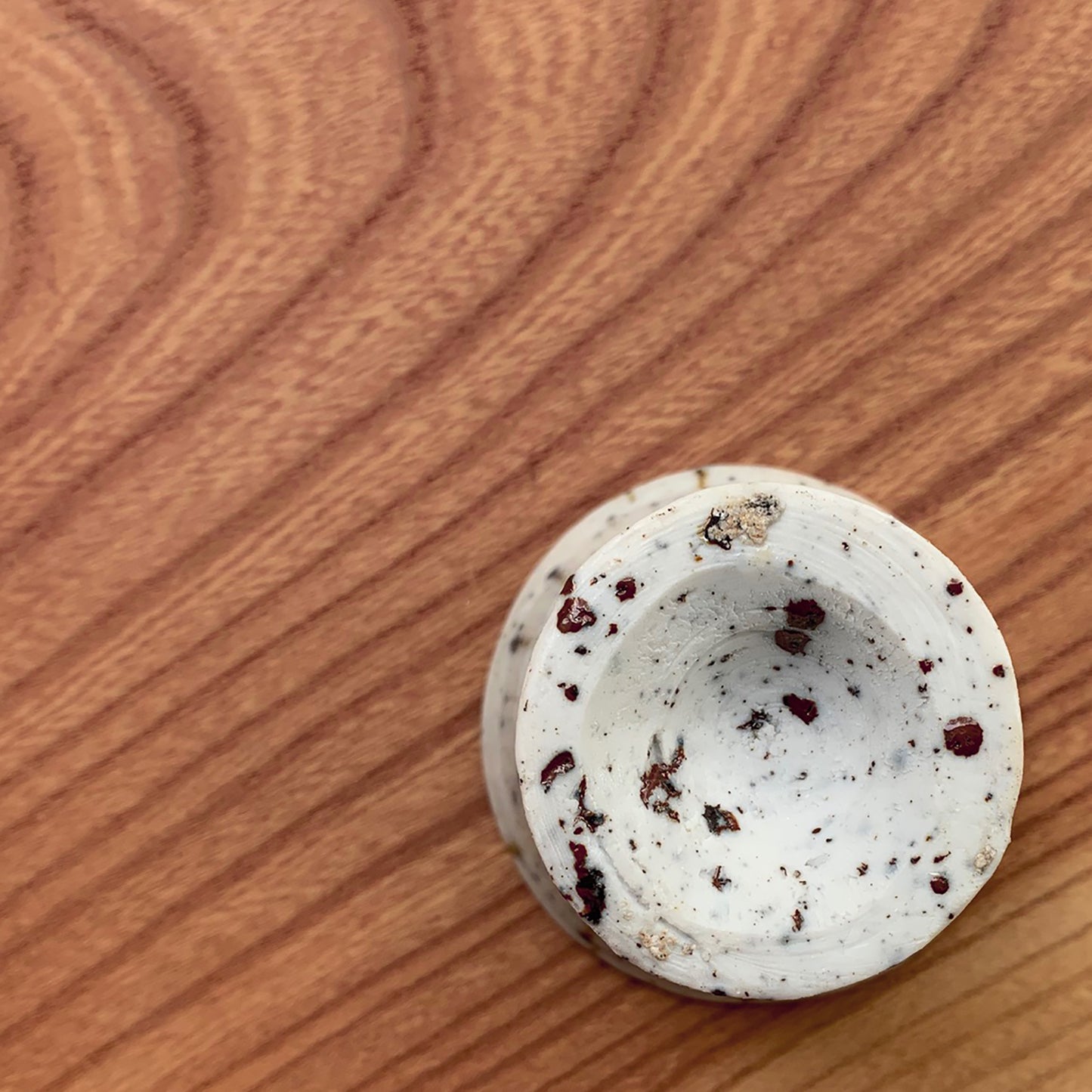The view of the bottom of the cup on the wood table. Wabi sabi feeling.
