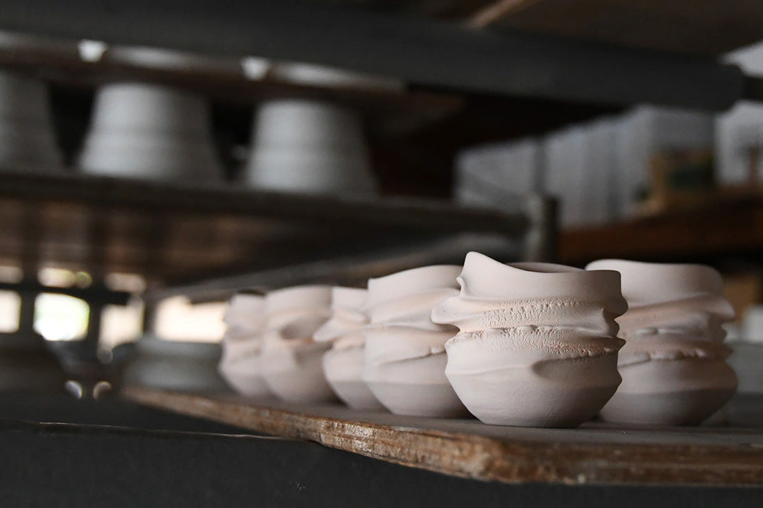 Handmade ceramic pieces drying on shelves inside Asato Ikeda’s pottery studio