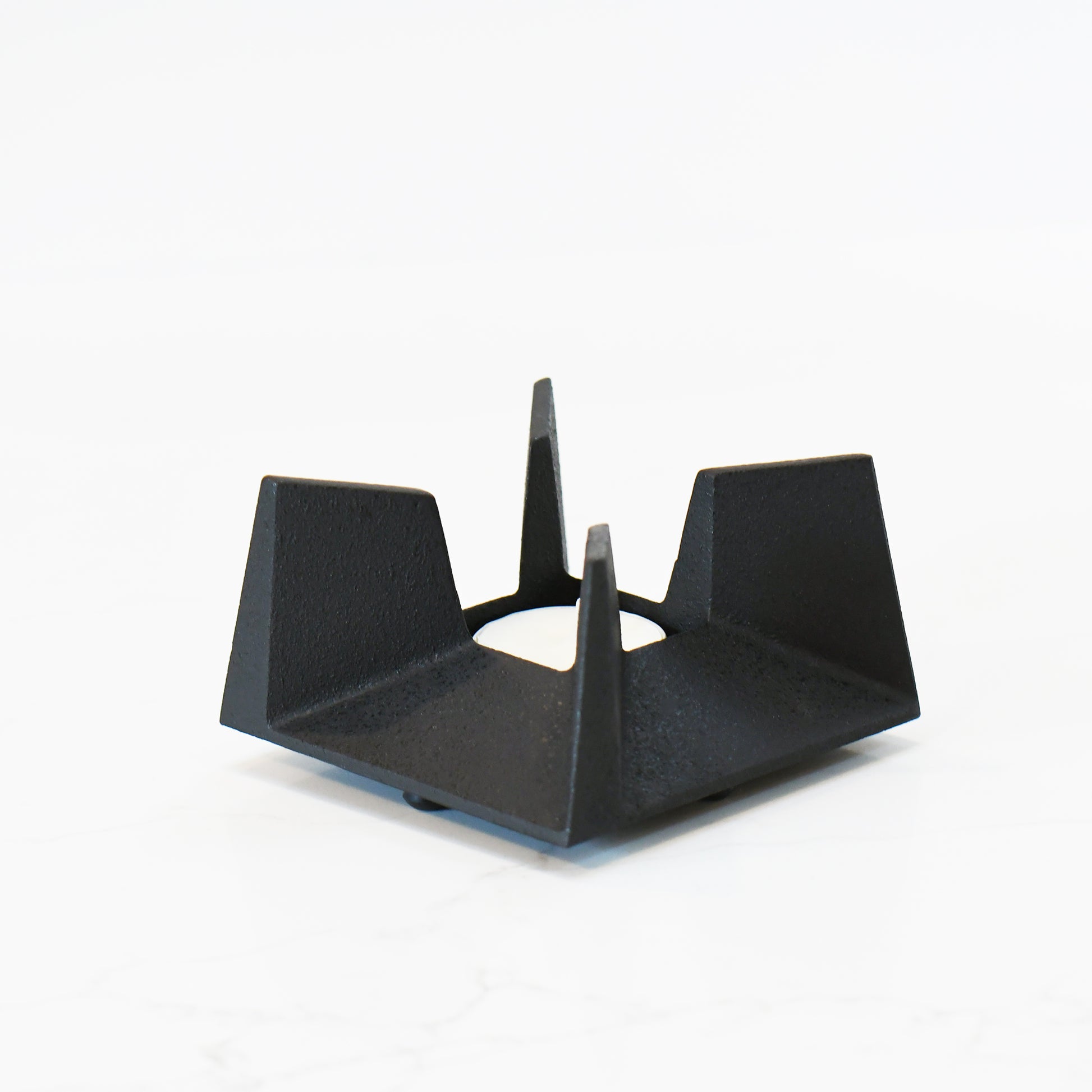 Side view of Japanese cast iron tea incense burner, highlighting its architectural form and open structure.