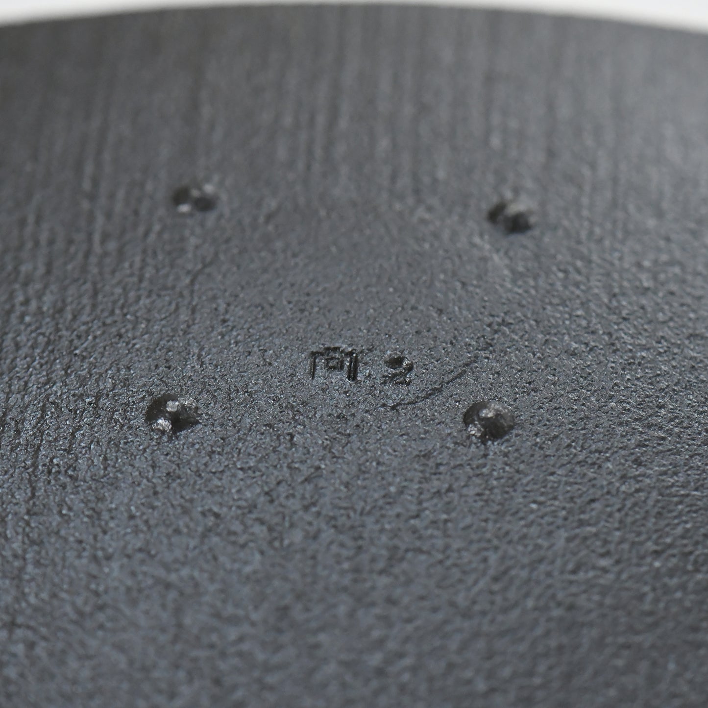 Close-up of a textured black surface with small raised dots
