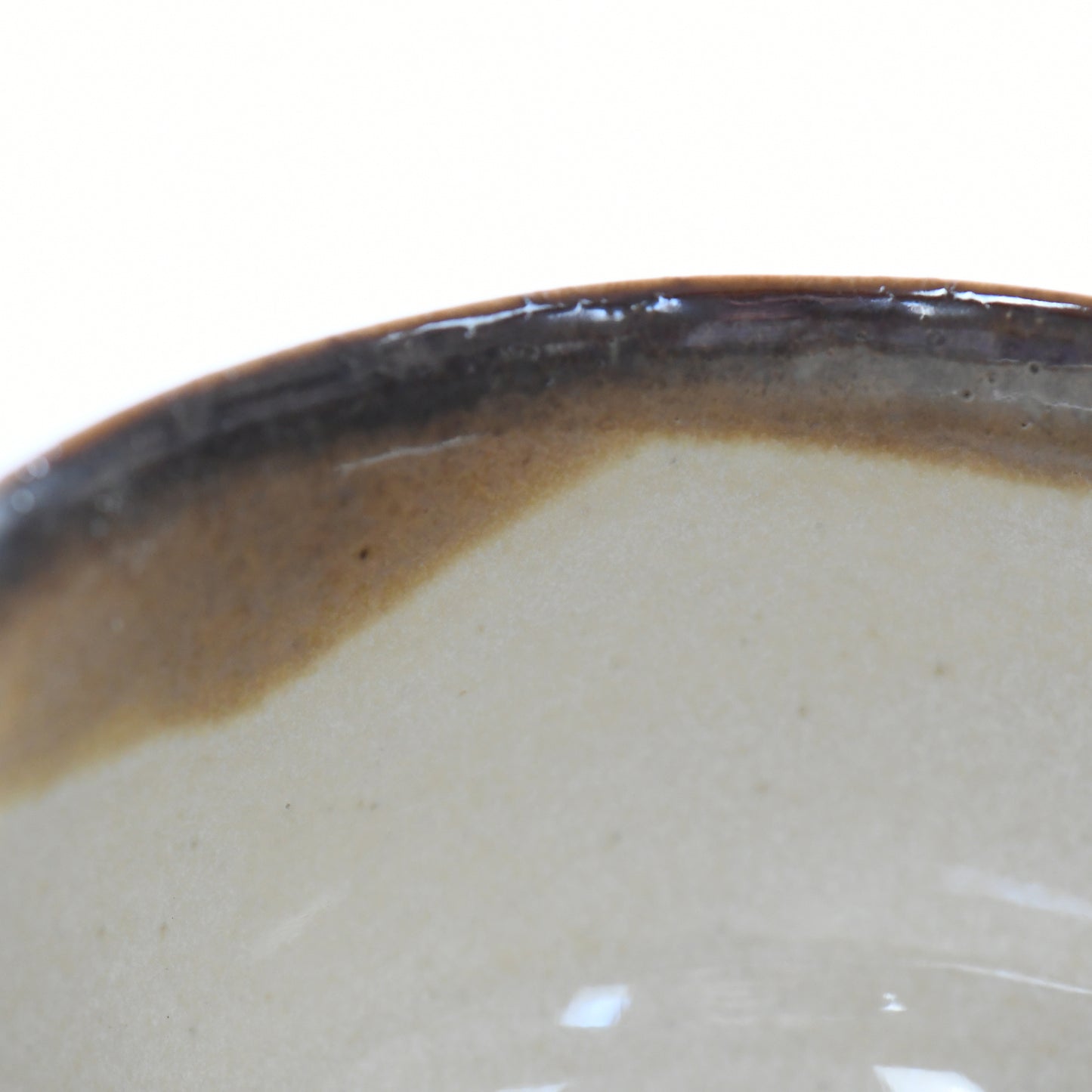 Close-up of glossy brown glaze transition on Yuhaku matcha bowl