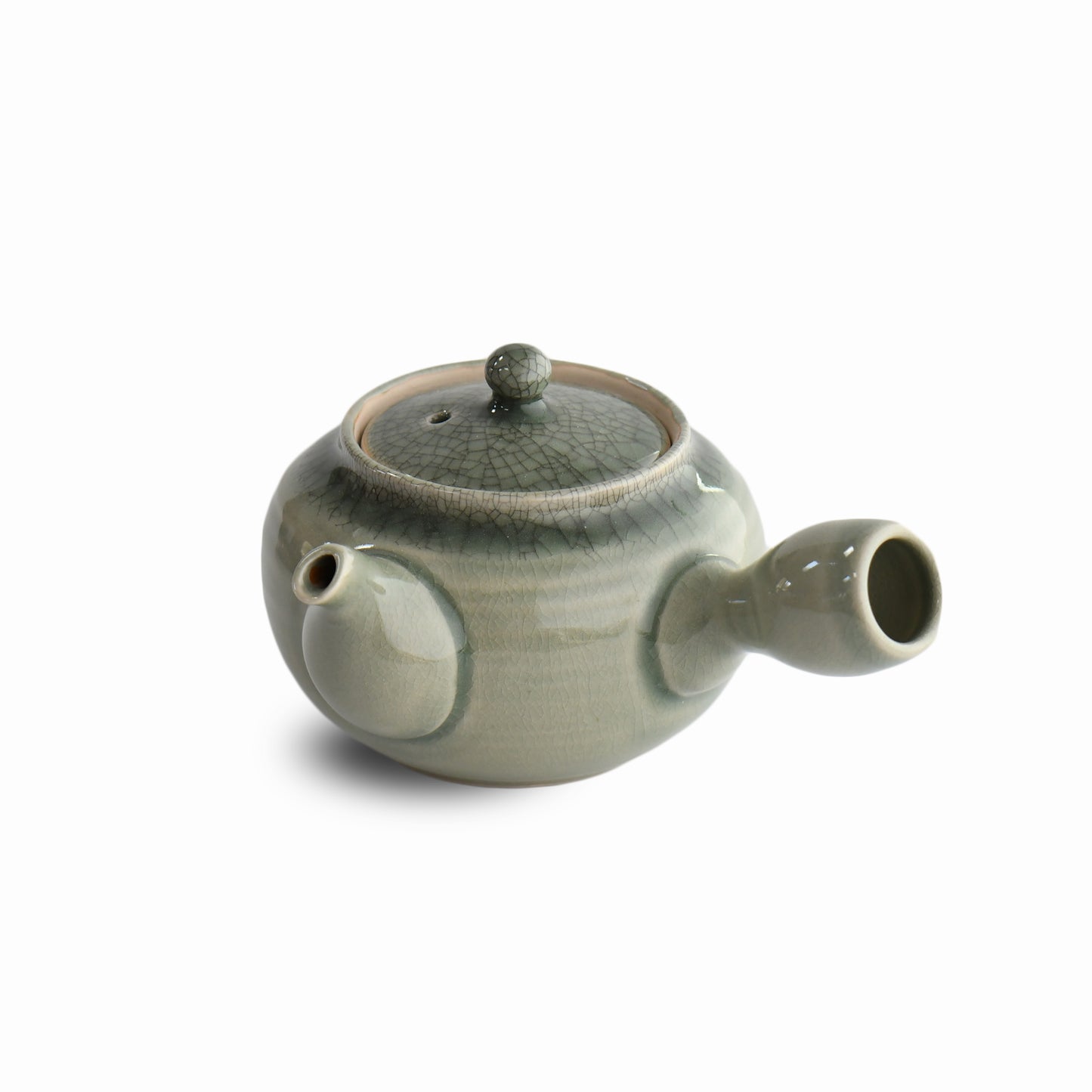 Japanese teapot with rounded body, crackle celadon glaze, and curved spout, handmade at Ikariya Kiln.