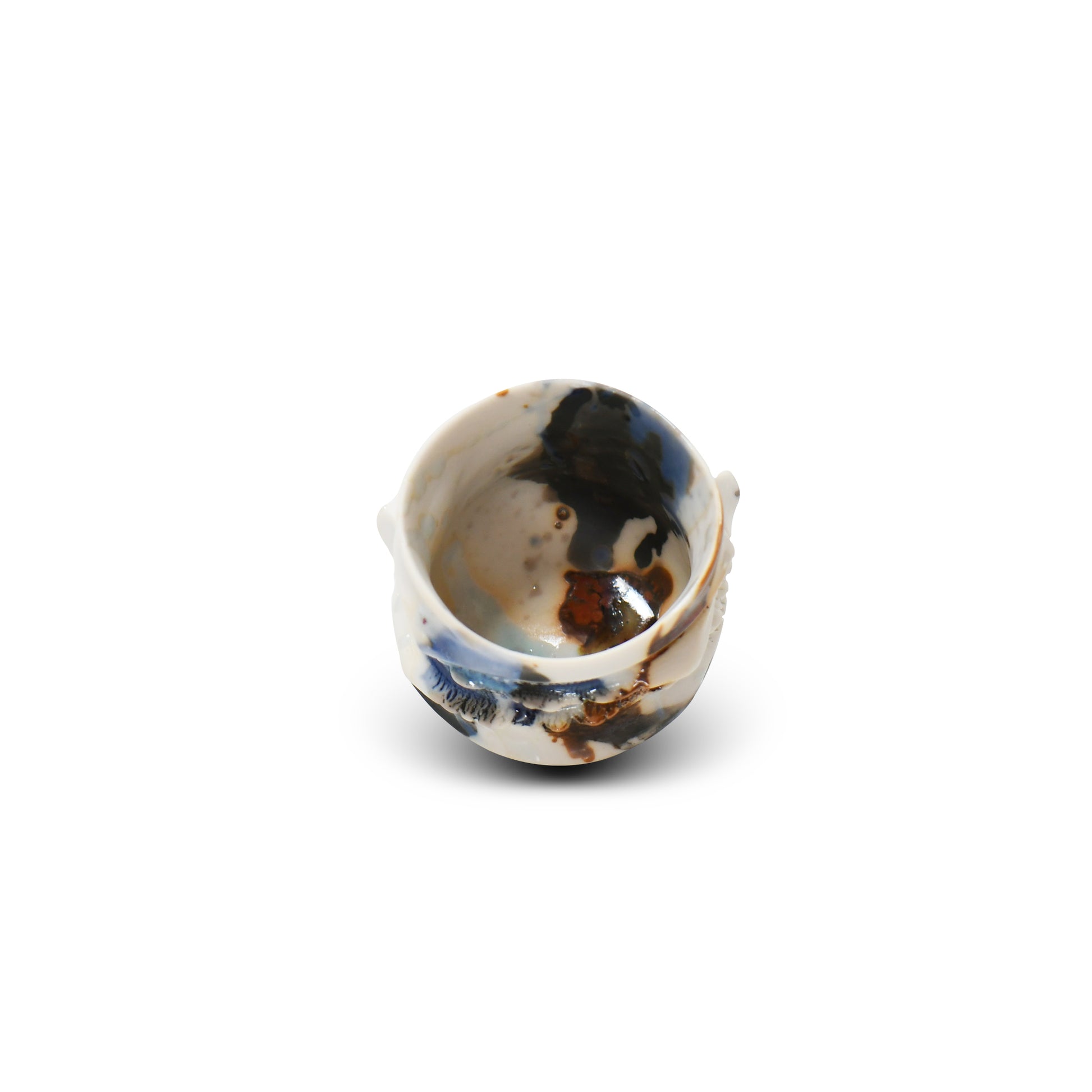 Top view of guinomi cup showing soft contours and deep blue and amber glazes pooling inside.