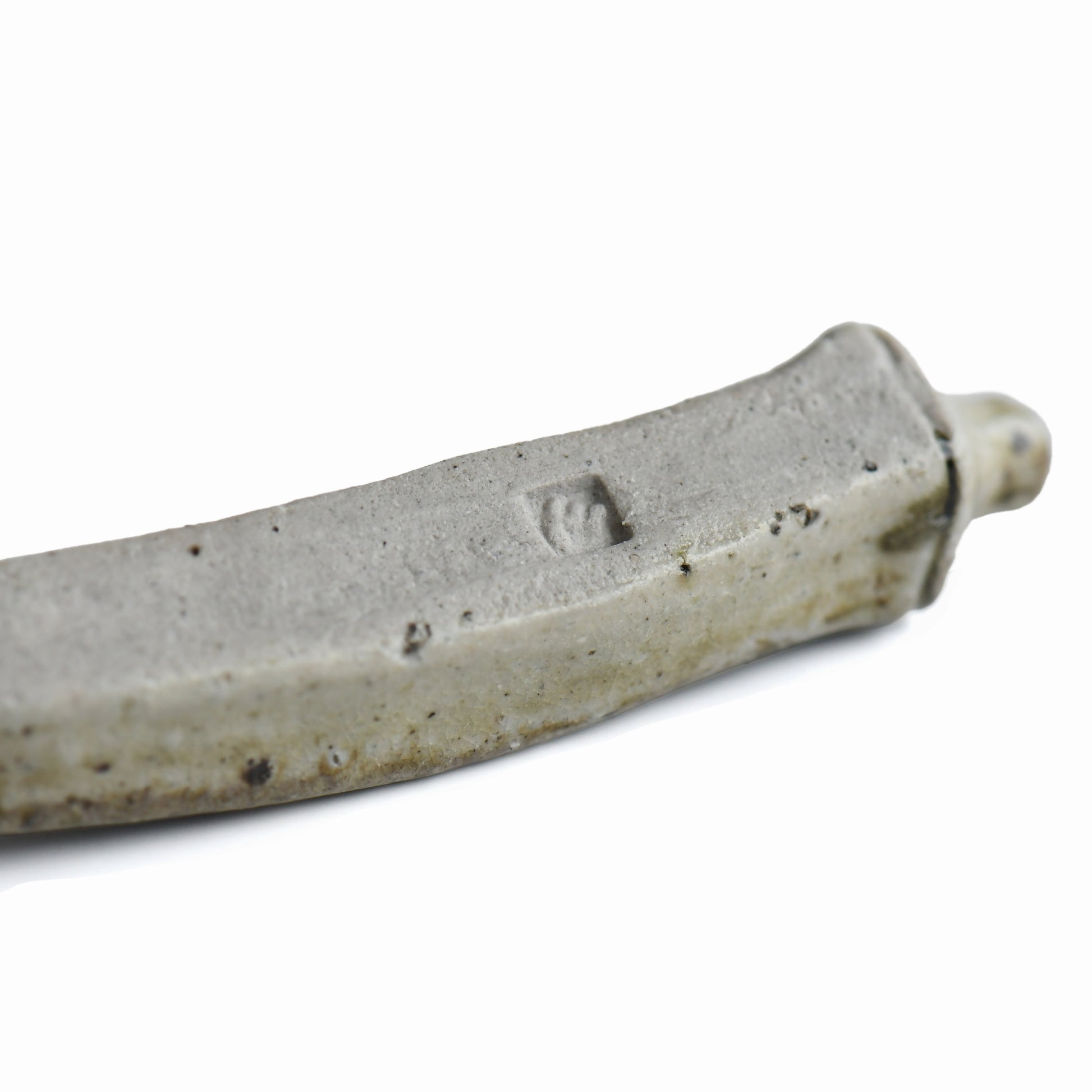 Close-up of the maker's mark on the handmade Bizen okra chopstick rest