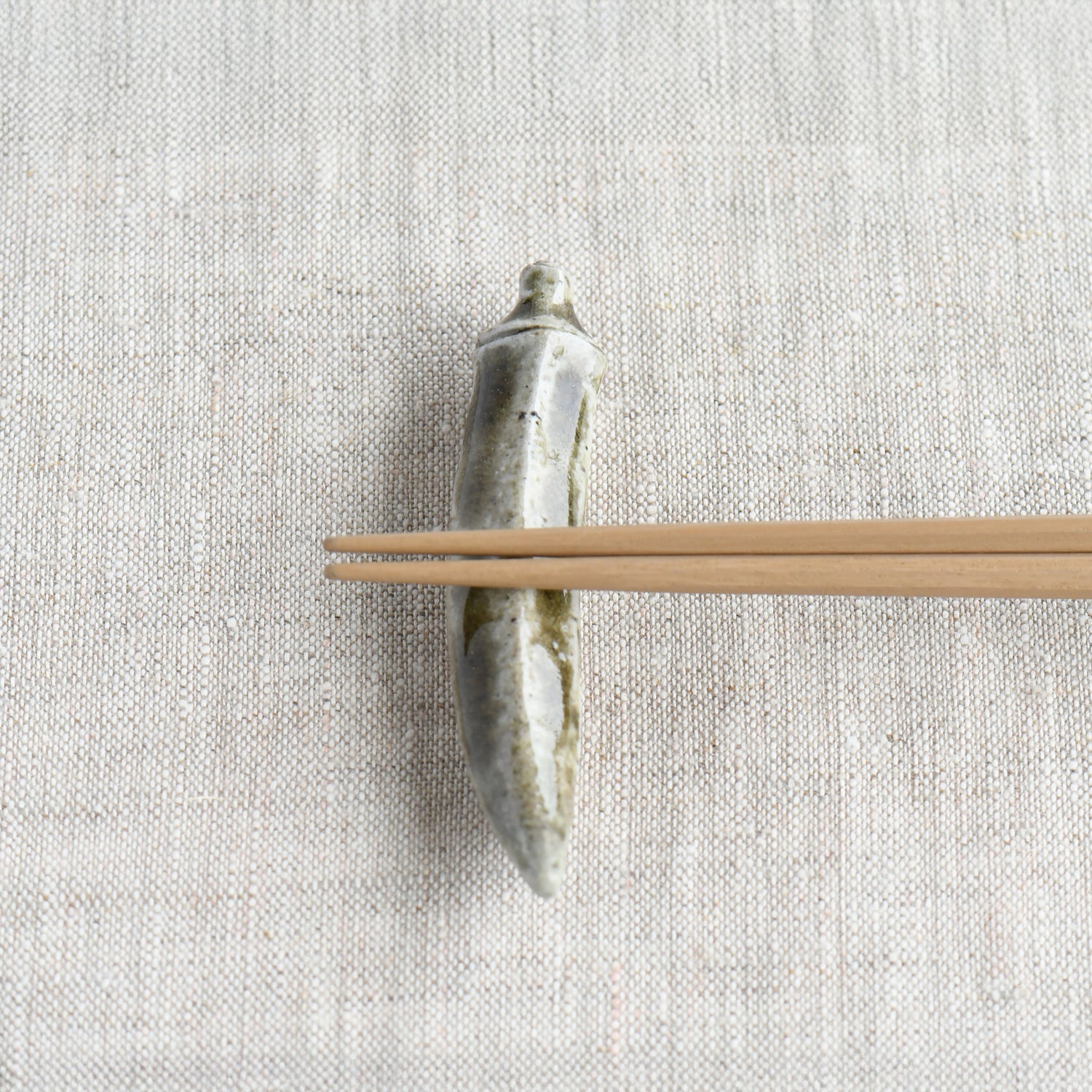 Bizen okra chopstick rest by Masato Miura shown with wooden chopsticks