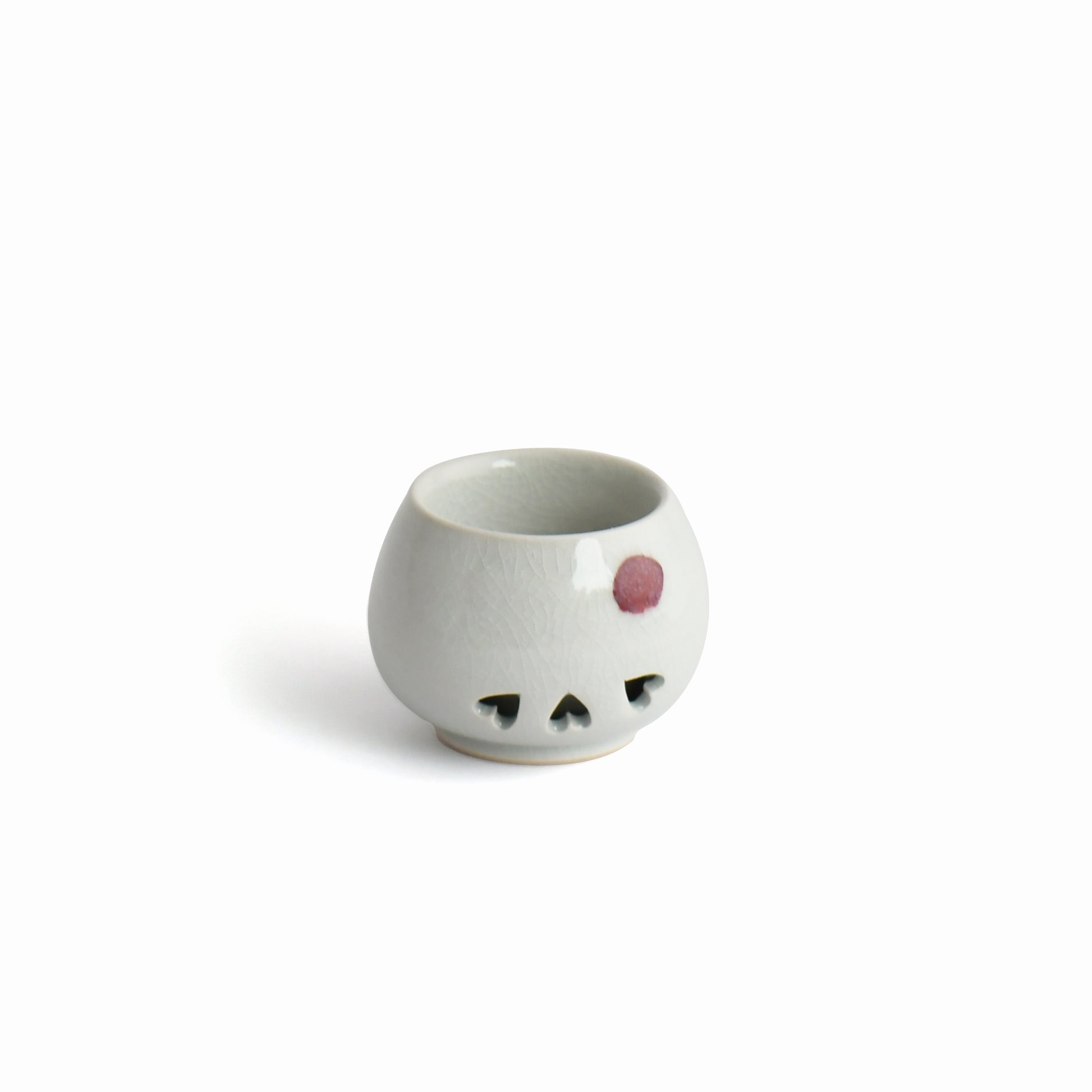 Side view of Shunme white sake cup with soft crackle glaze texture