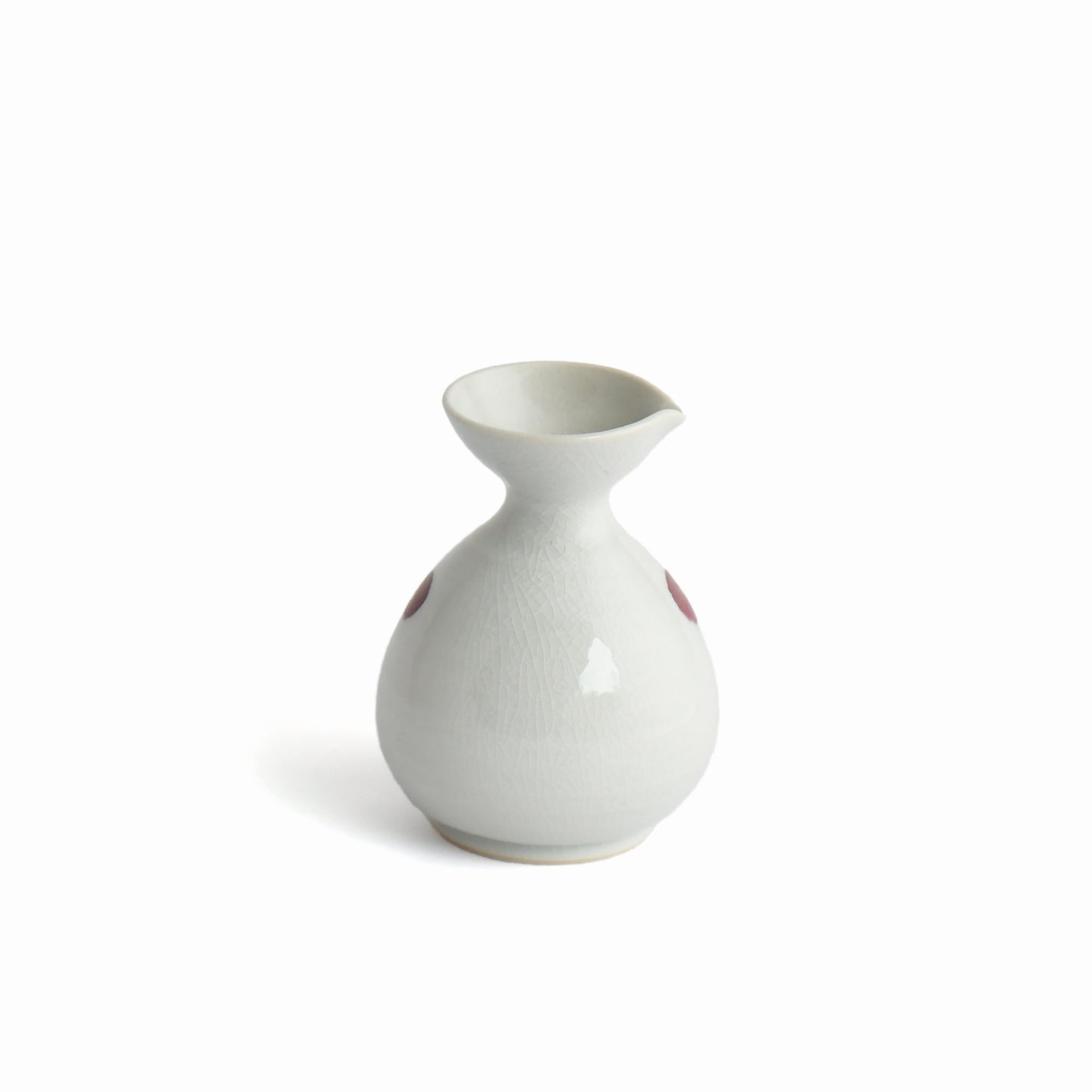 Back view of Shunme white sake carafe with soft crackle glaze texture.