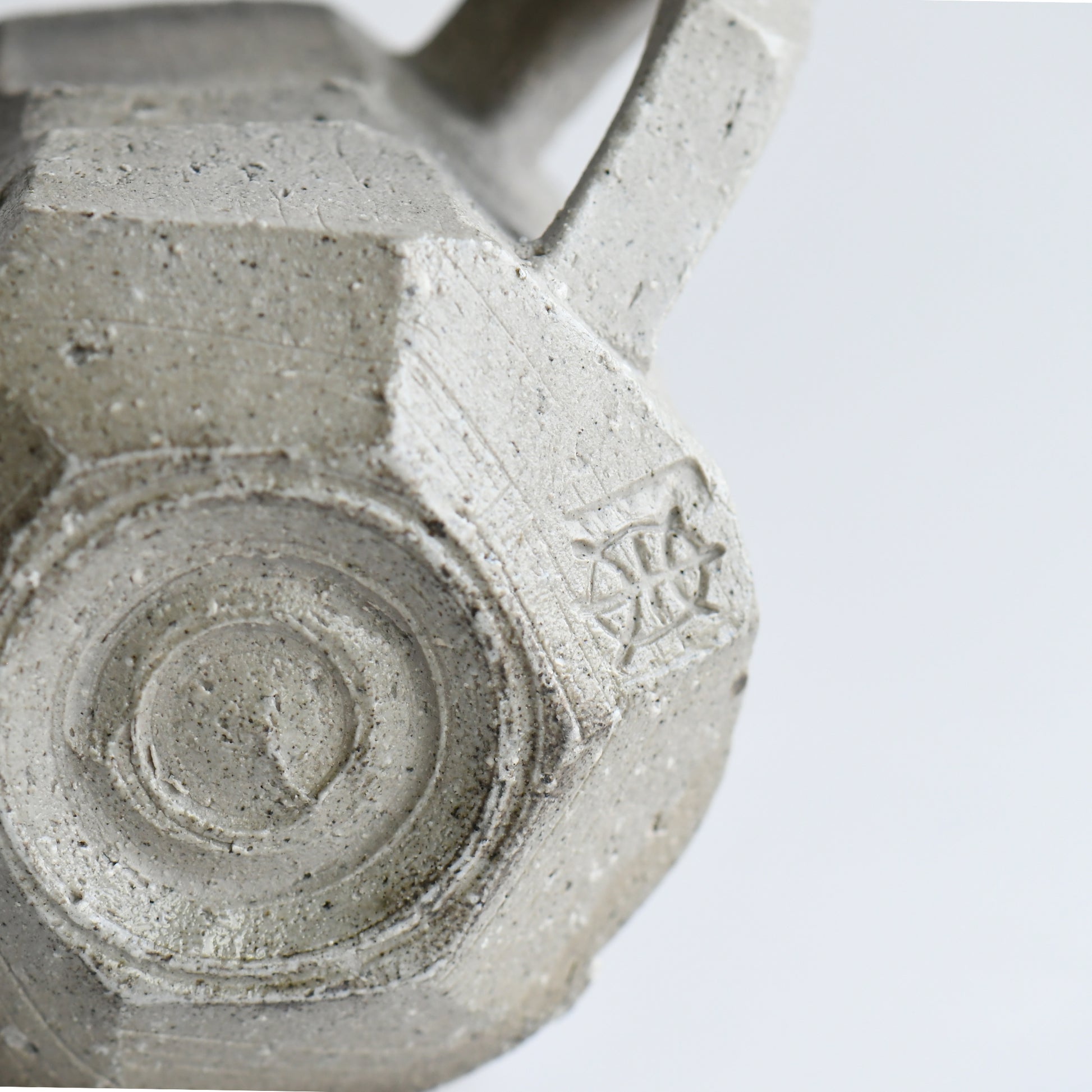Bottom view of Seihitsu Sueki Mug Medium #2 with circular foot ring and impressed artist mark on textured clay base.