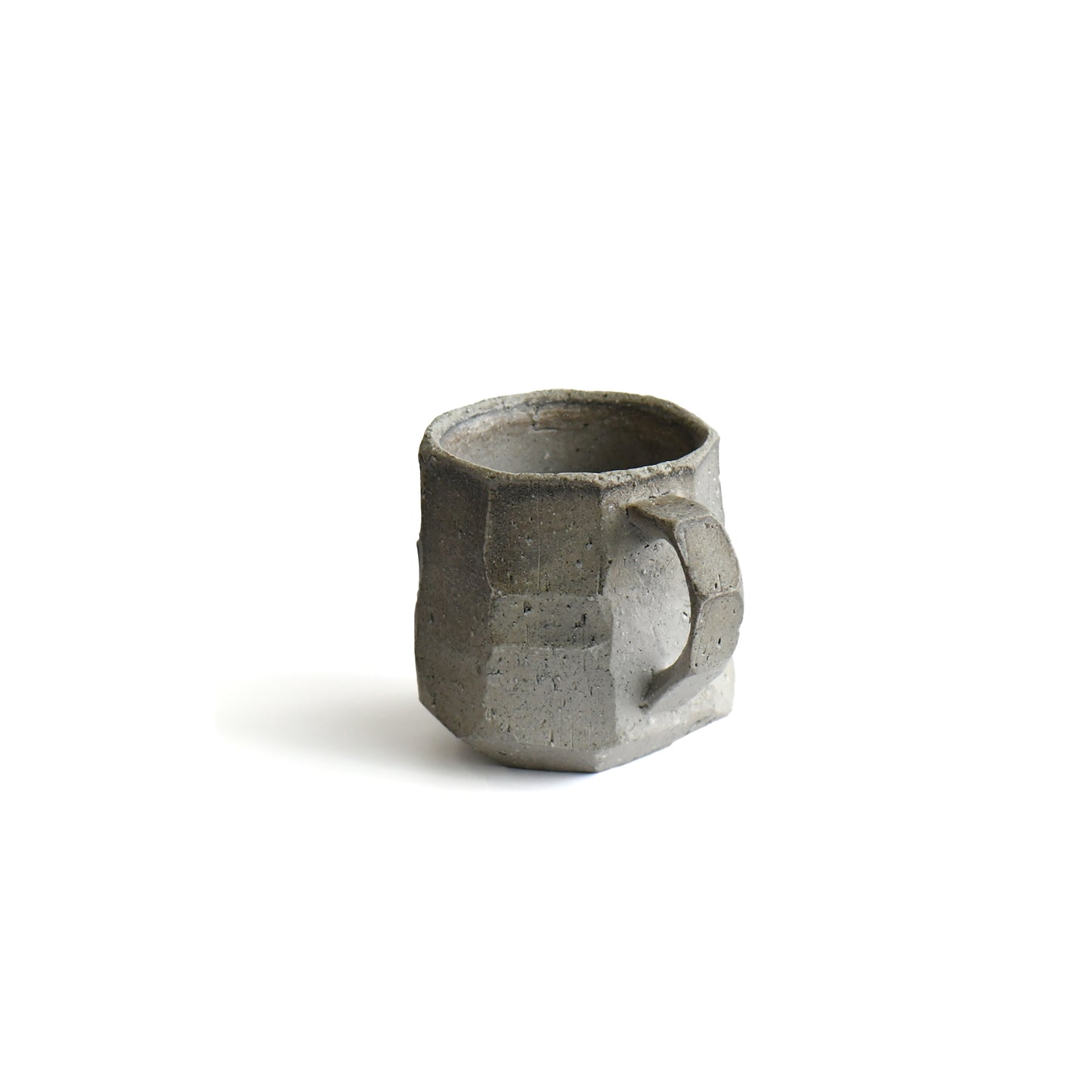 Close-up of carved stoneware surface and angular handle of Seihitsu Sueki Mug Medium #2, highlighting matte texture and hand-formed edges.