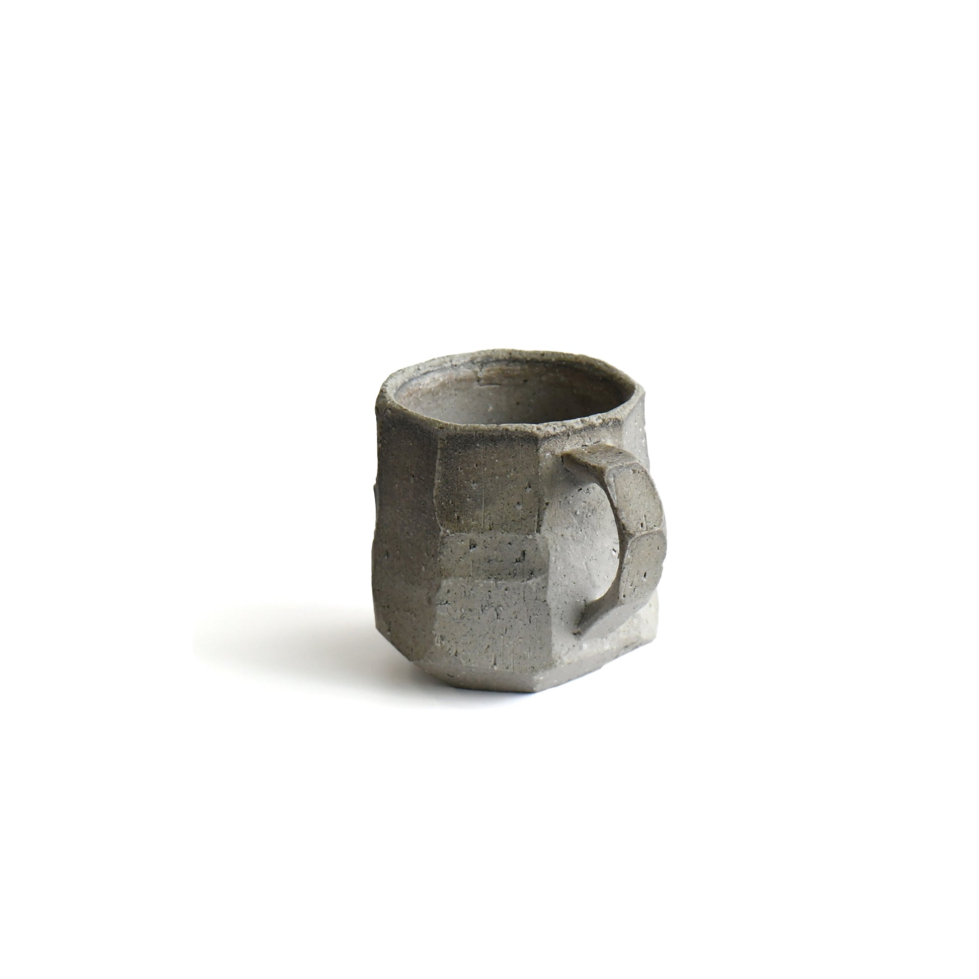 Close-up of carved stoneware surface and angular handle of Seihitsu Sueki Mug Medium #2, highlighting matte texture and hand-formed edges.