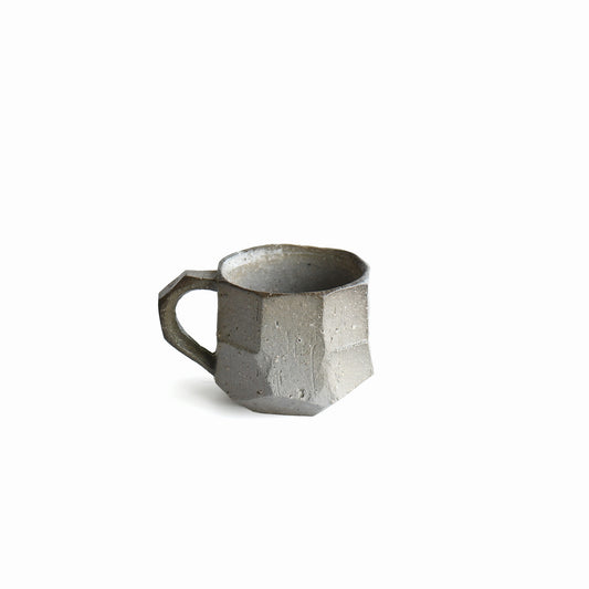 Back view of Seihitsu Sueki Mug Small #1 showing carved planes, iron-speckled clay texture, and balanced handmade form.