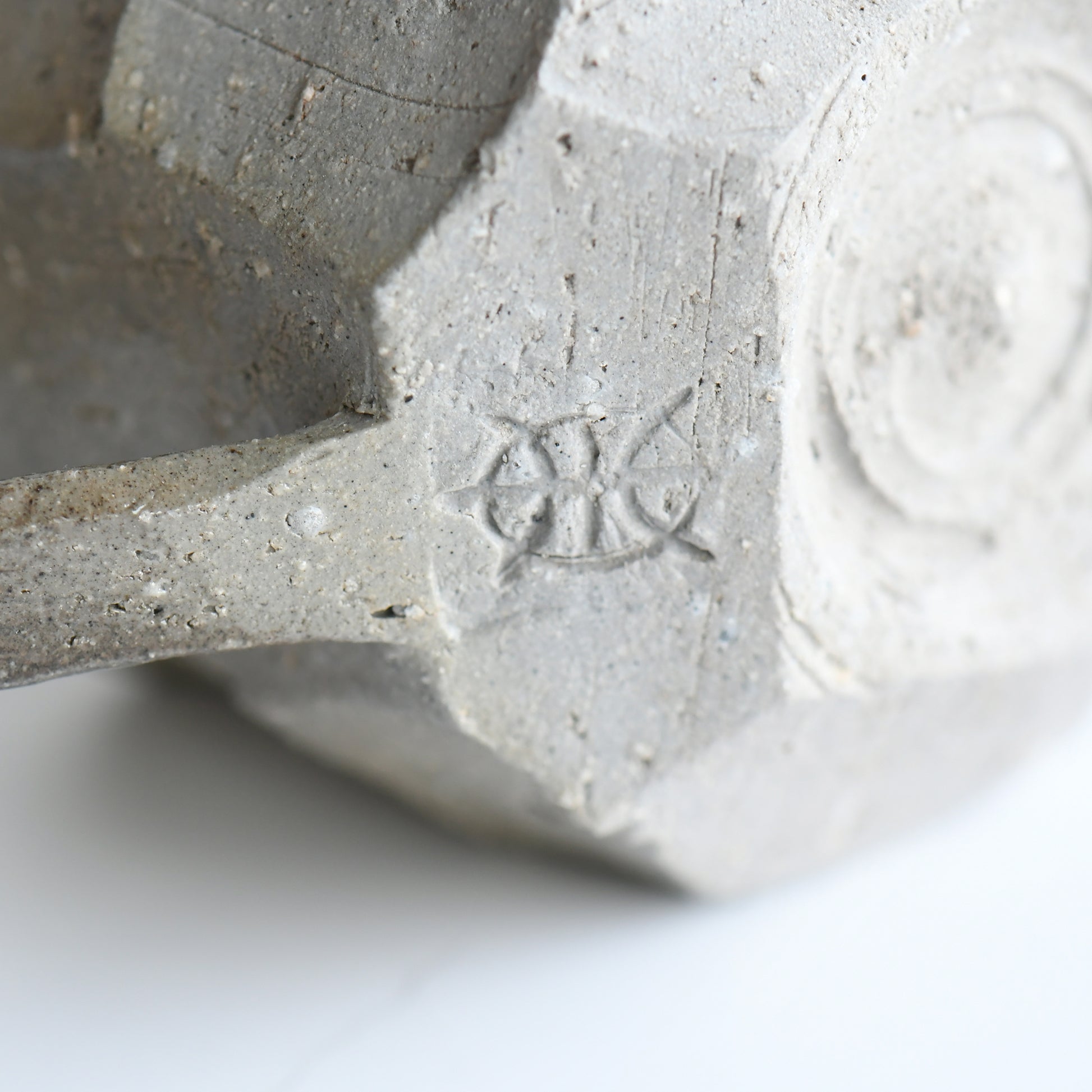 Bottom view of Seihitsu Sueki Mug Small #1 with circular foot ring and impressed artist mark on textured clay base.