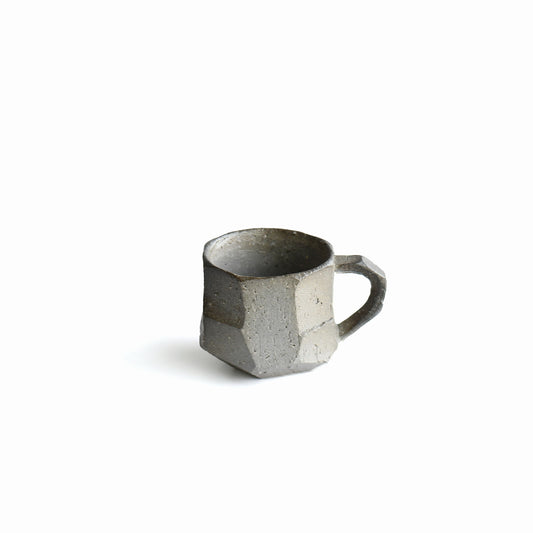 Seihitsu Sueki Mug Small #1 by Manabu Suehiro, 4 oz Japanese stoneware mug with faceted ash-gray surface and compact silhouette, front view.