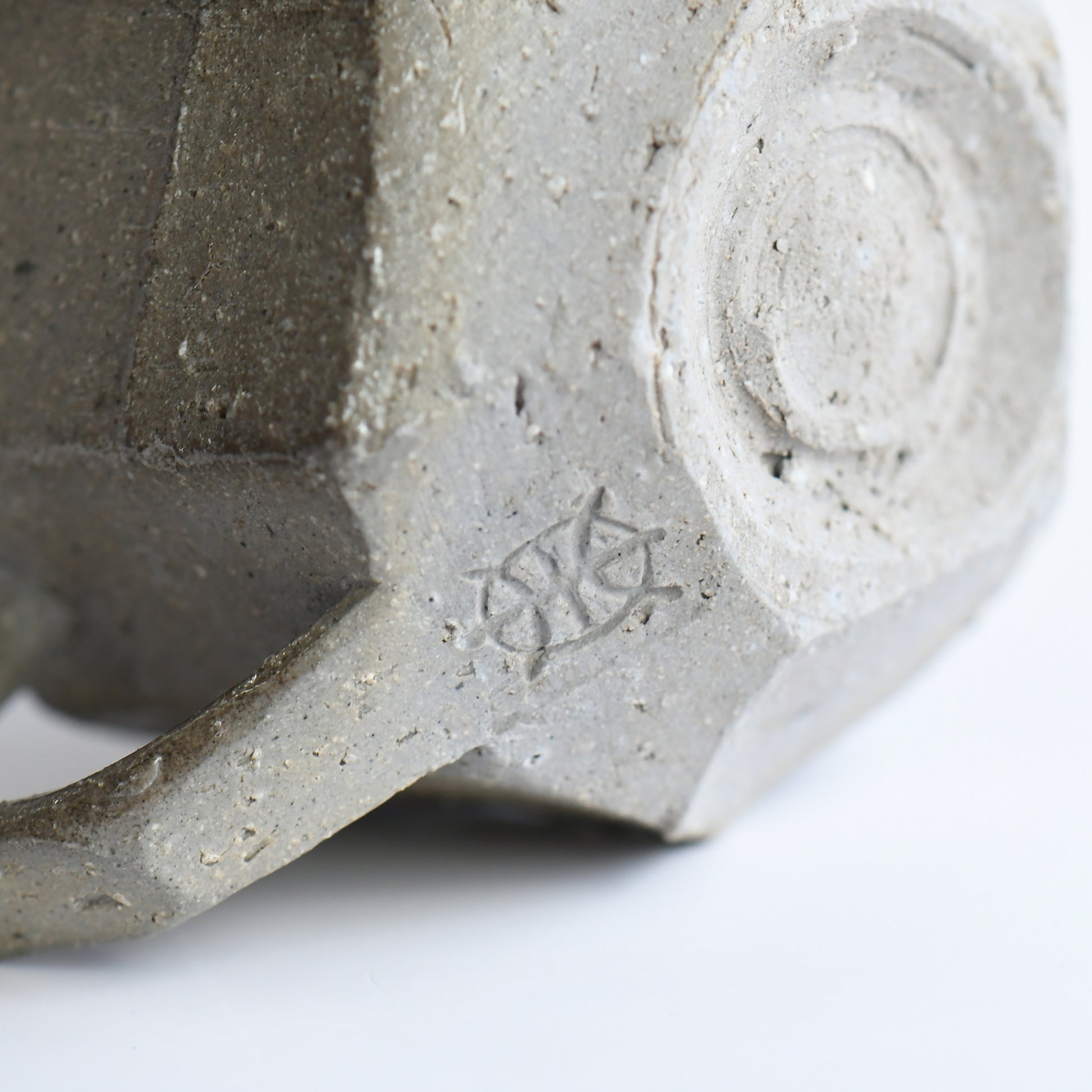 Bottom view of Seihitsu Sueki Mug Small #2 with circular foot ring and impressed artist mark on textured clay base.