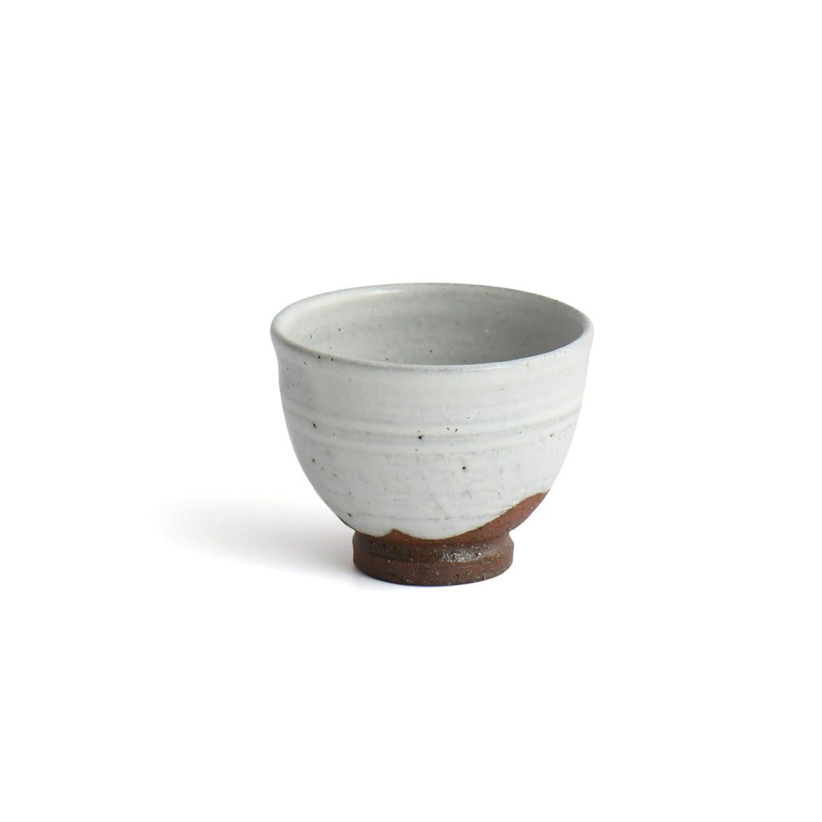 Back view of Shirayuki yunomi showing white kohiki glaze and warm reddish-brown Mashiko clay. 