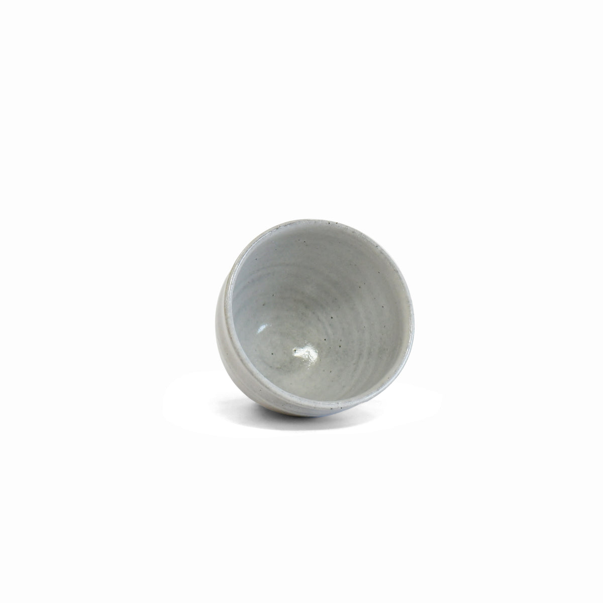 Interior of handmade Shirayuki yunomi with soft white kohiki glaze and subtle throwing marks