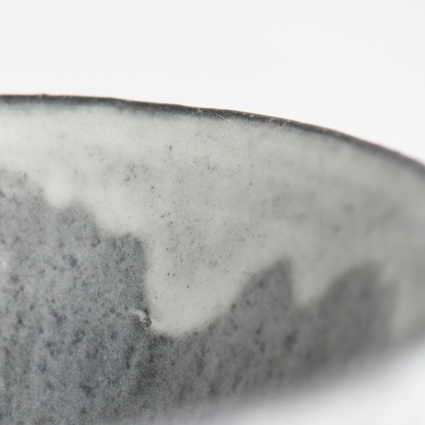 Close-up of flowing white glaze along the rim of the Sumine Rice Bowl by Takeshi Honda.