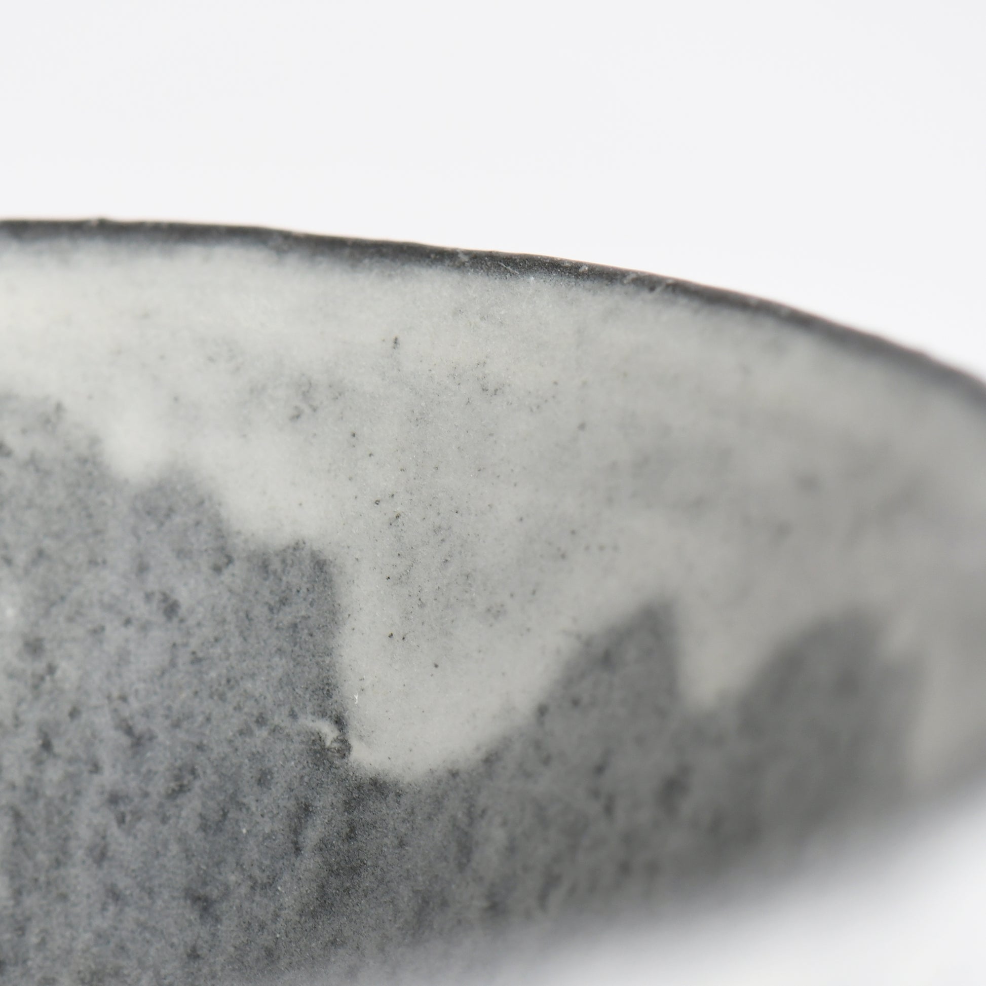 Close-up of flowing white glaze along the rim of the Sumine Rice Bowl by Takeshi Honda.