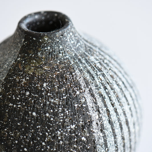small Japanese ceramic bud vase with faceted form and speckled glaze detail
