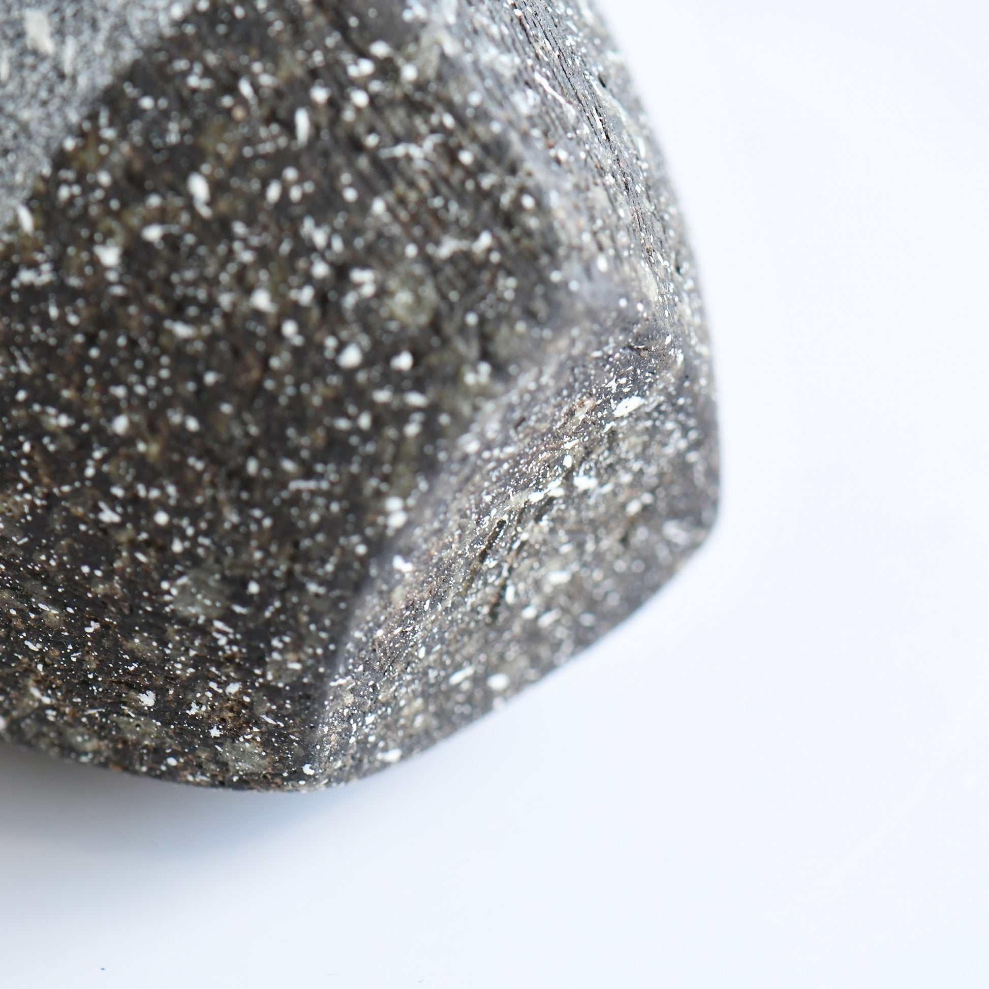 close-up of textured glaze on handmade Japanese ceramic vase with natural speckling and artisan mark