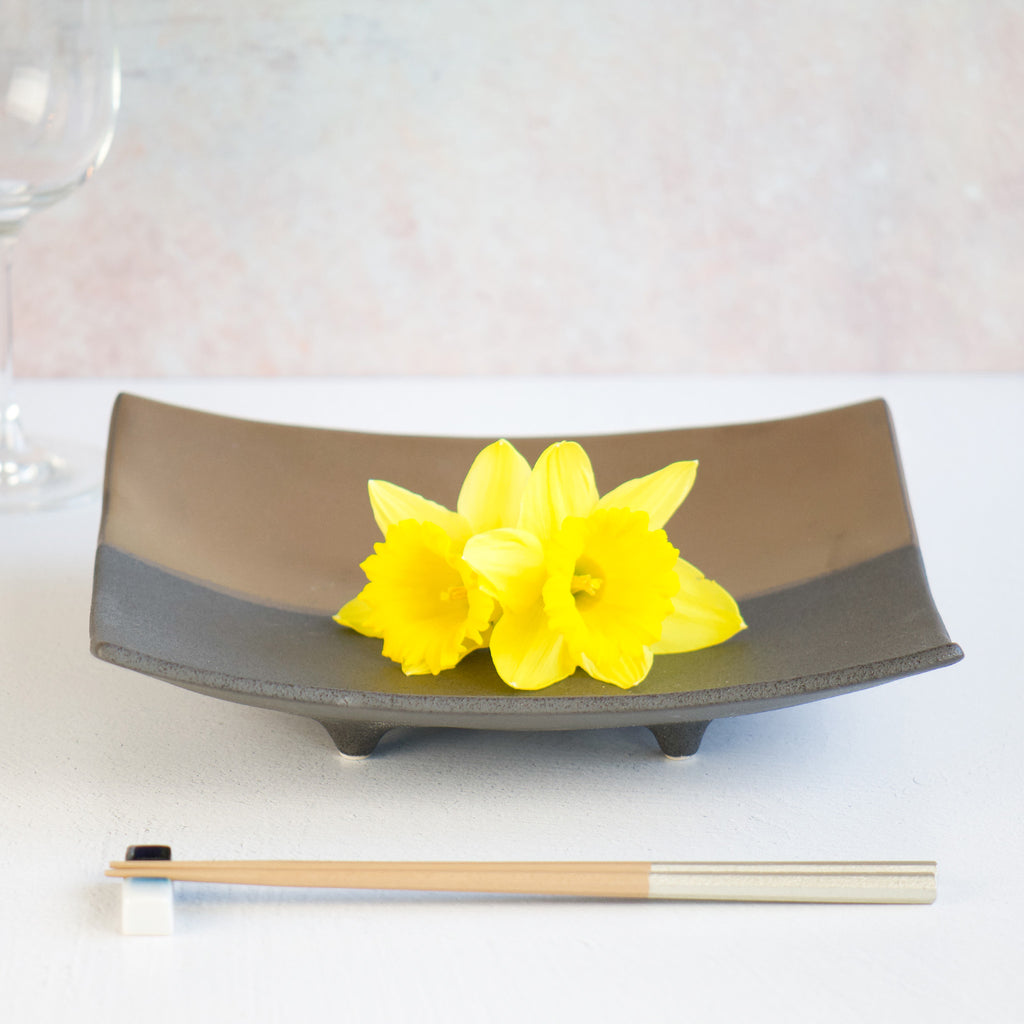 The plate was set with chopsticks and a glass. The plate was naturally up on 4 corners. Beautiful and luxurious look.