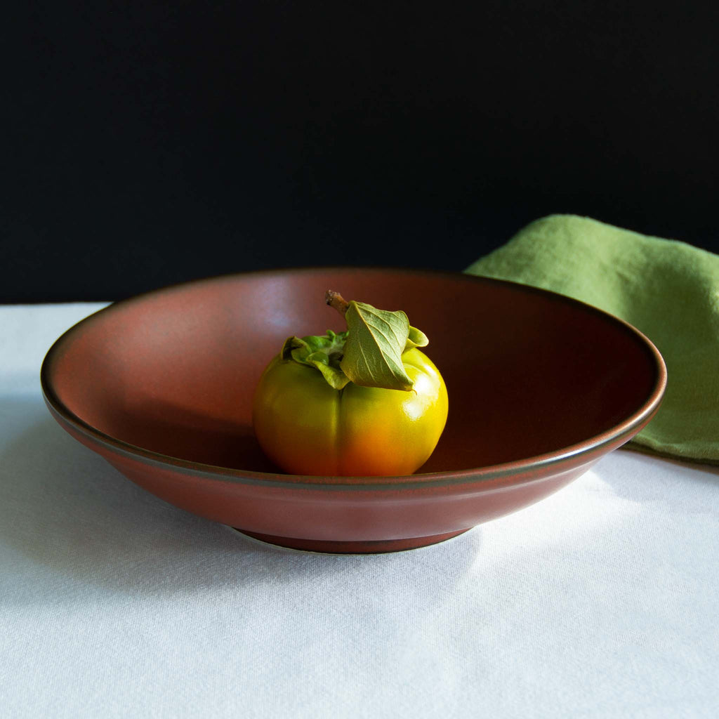Deep red pasta bowl with thin black outline at rim - modern design.