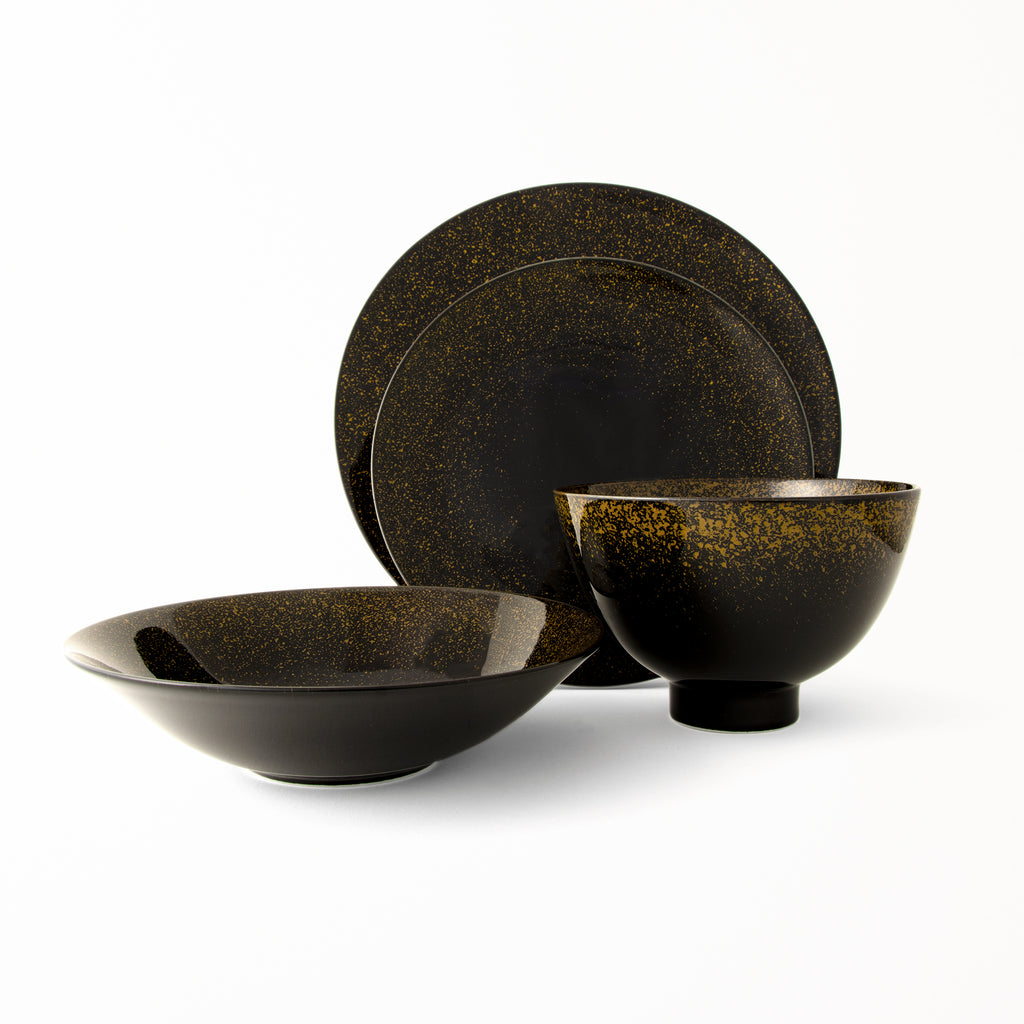 This is a 4 pieces dinnerware set that includes 11" dinner plate, 9" salad plate, 8" shallow bowl and 6" deep bowl. Black base and gold sparkles with glossy glaze. Microwave and dishwasher safe. Gorgeous set.