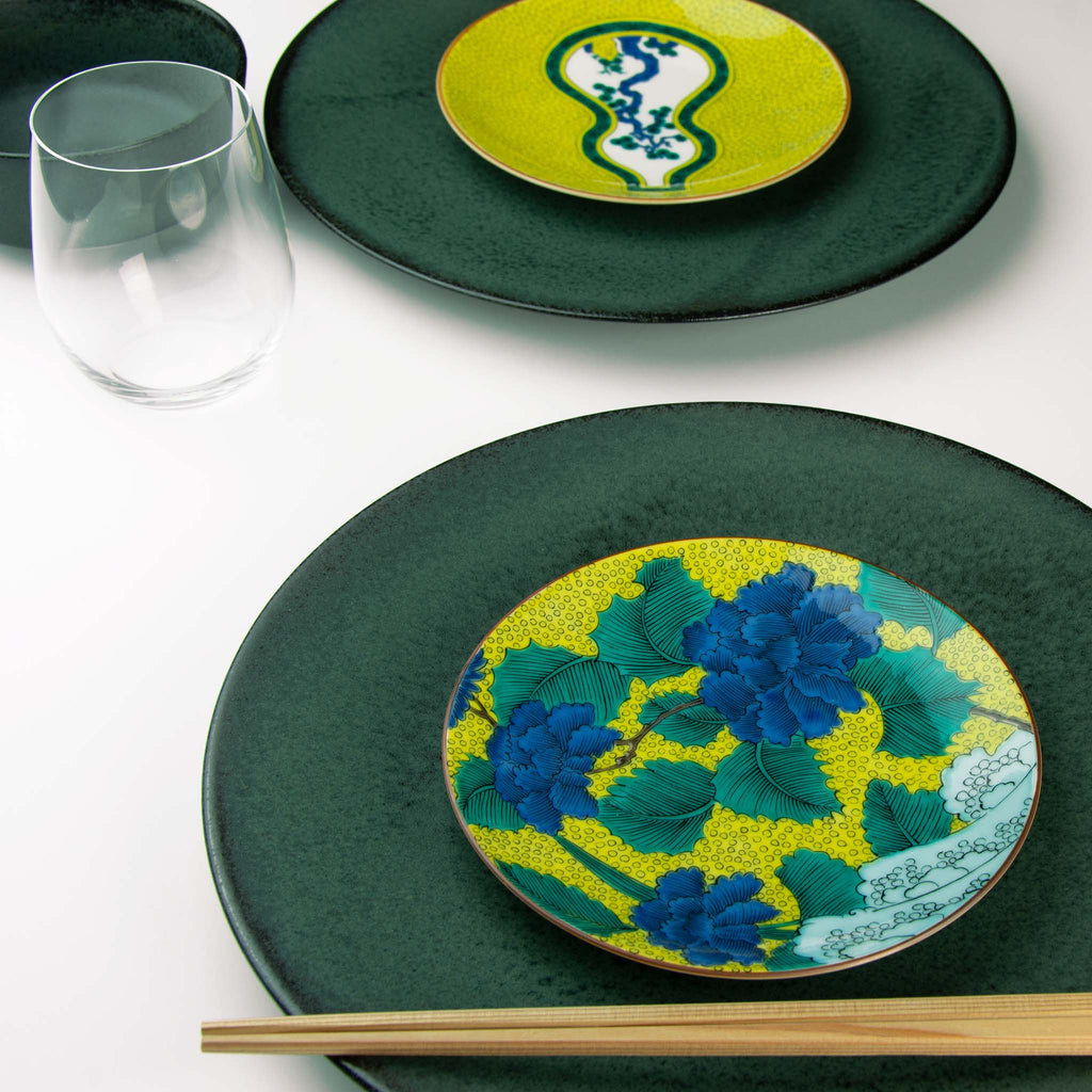 Rich blue peonies and green leaves set on a background of yellow and blue waves.  Paired with Koku dinnerware.