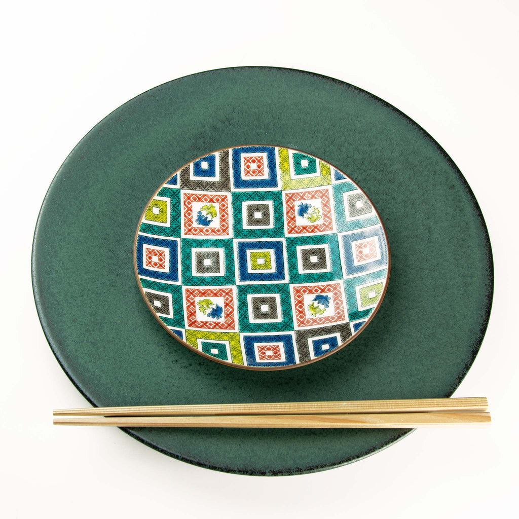 Red, blue, yellow, green, gray, square patterns on round dish paired with Koku dish