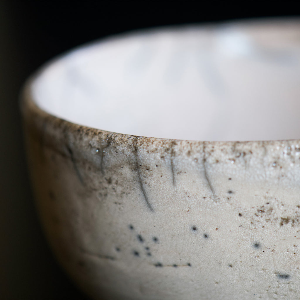 Close look of the edge of the bowl. Black spots are like sumi-e painting which is Japanese traditional painting art.