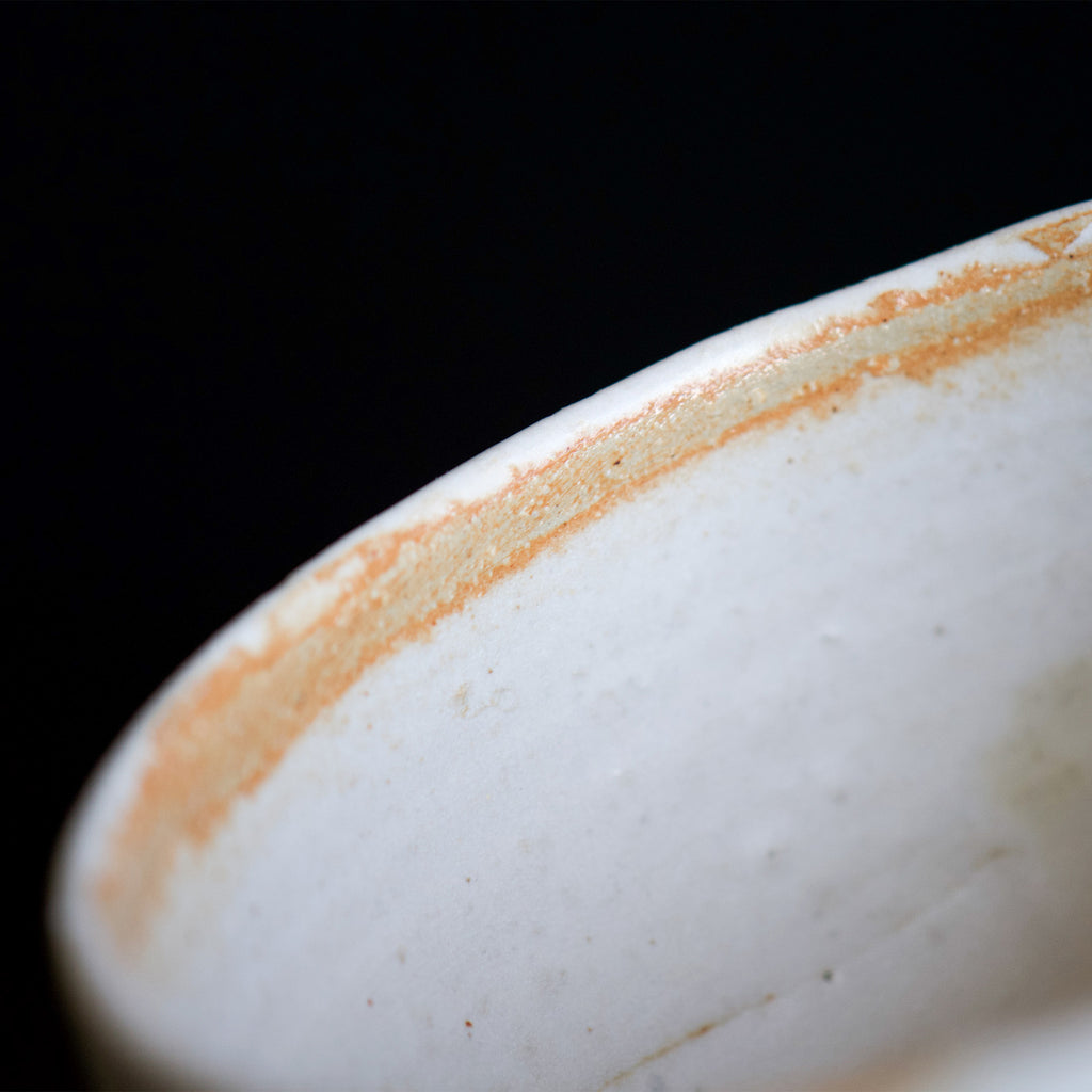 Close up view of the inside of the bowl. About the half of the edge has a half inch line of light brown color.