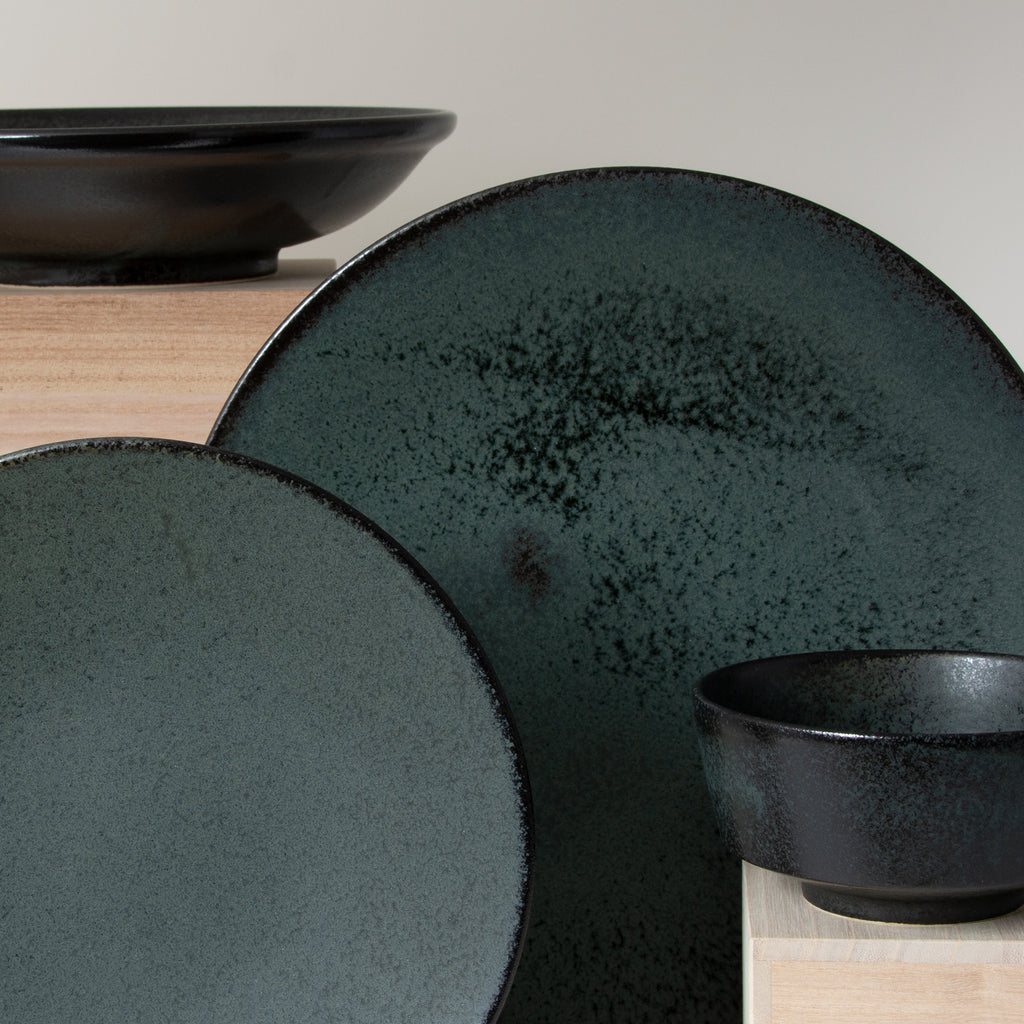 Koku 4-piece set includes semi-gloss black and matte grey glazed dinner and salad plates and pasta and rice bowls.